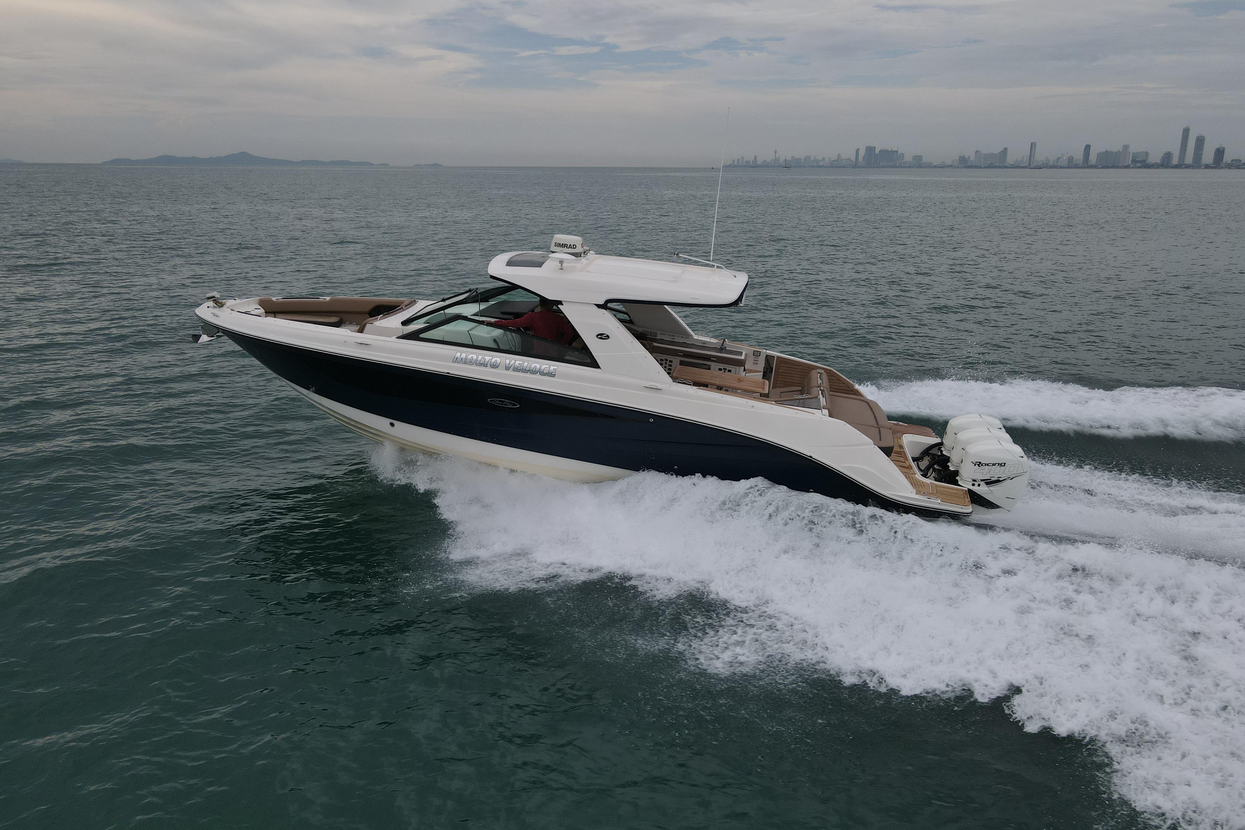 2019 Sea Ray SLX 400 Outboard cruising on open water with city skyline in background.