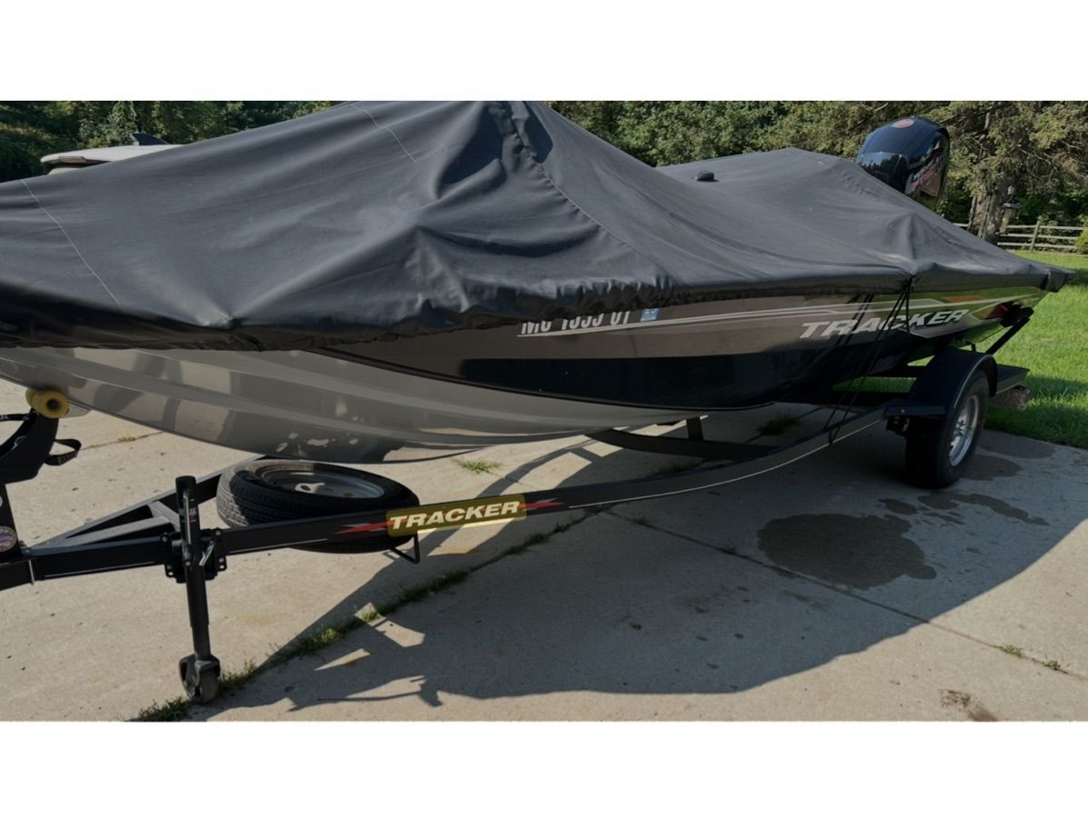A 2022 Bass Tracker 195TXW boat, covered and parked on a trailer.