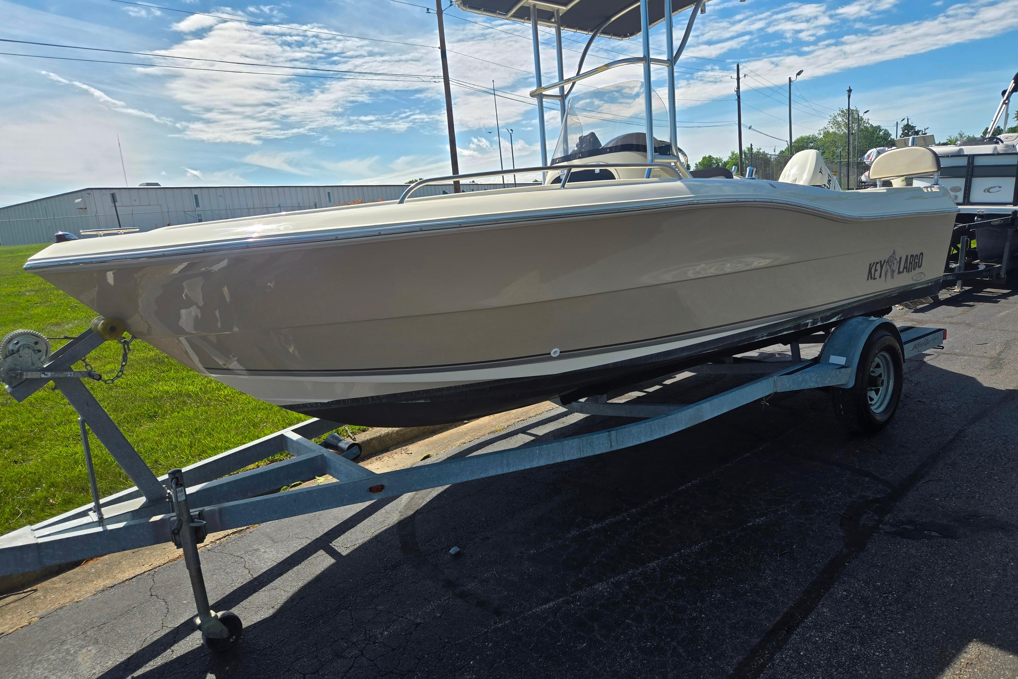 2016 Key Largo 2000CC boat on trailer under clear sky.