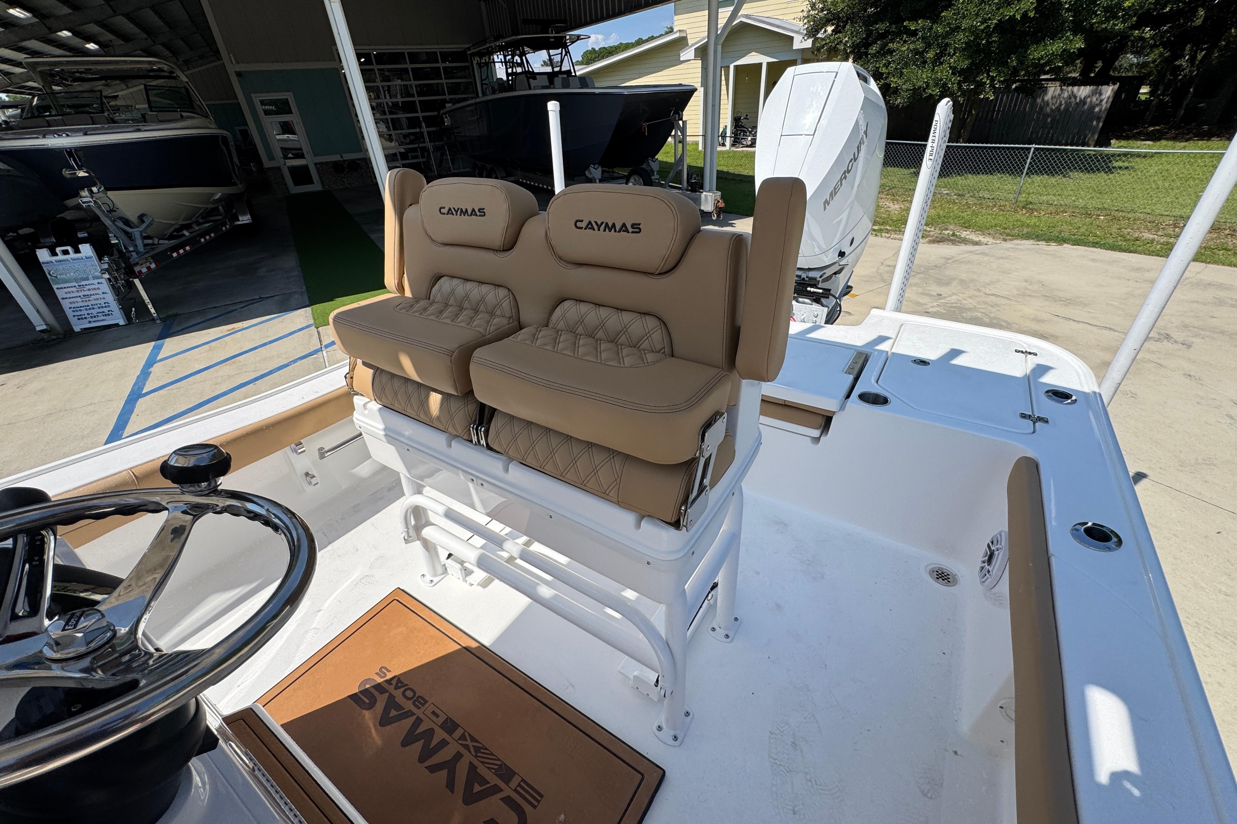 2027 Caymas 26 HB boat interior with tan seating and steering wheel.