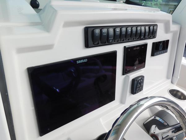 2025 Sailfish 232 CC dashboard with Simrad display and control panel.
