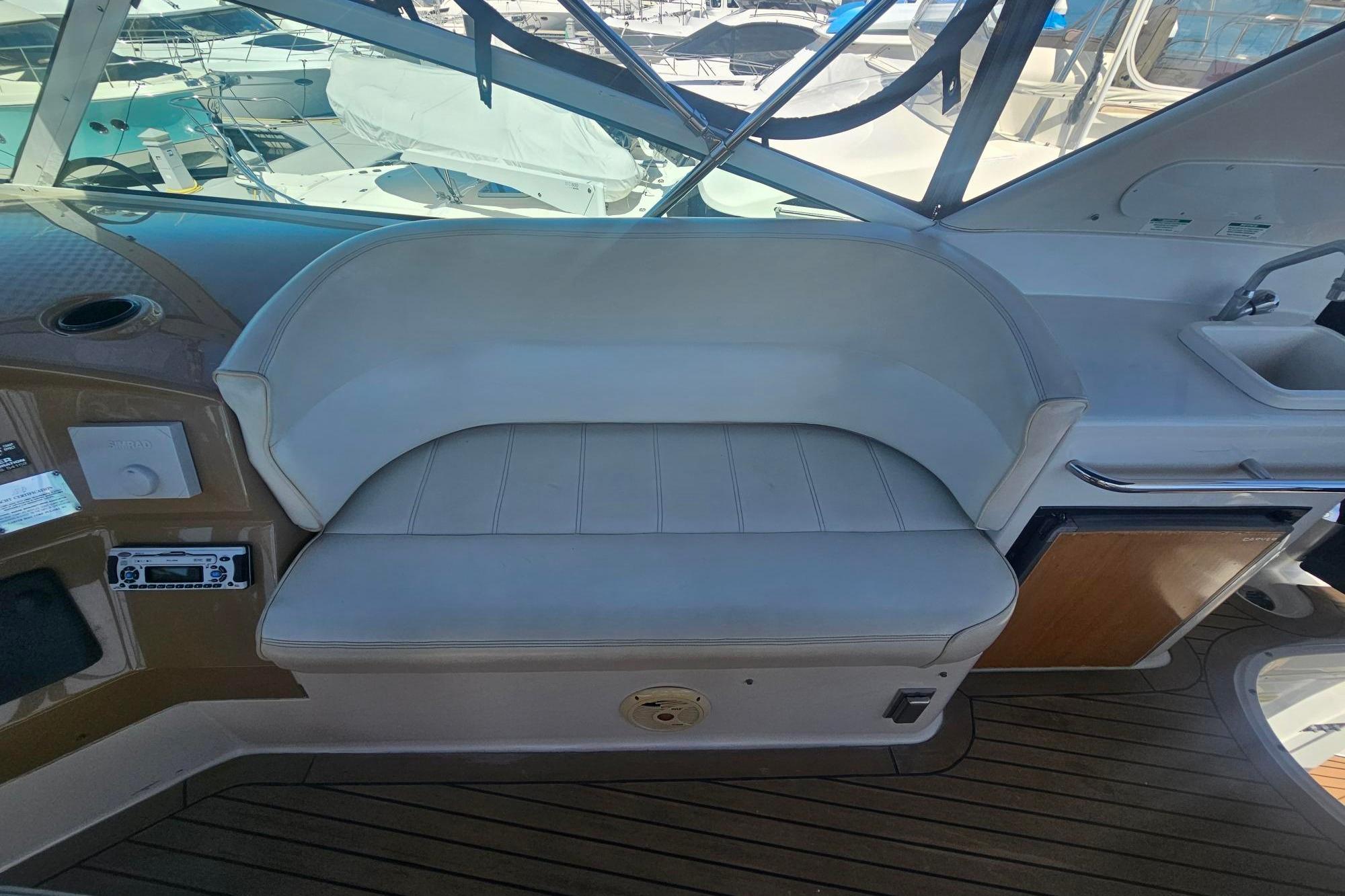 Interior seating of 2002 Carver 450 Voyager Pilothouse yacht, featuring a cushioned bench.