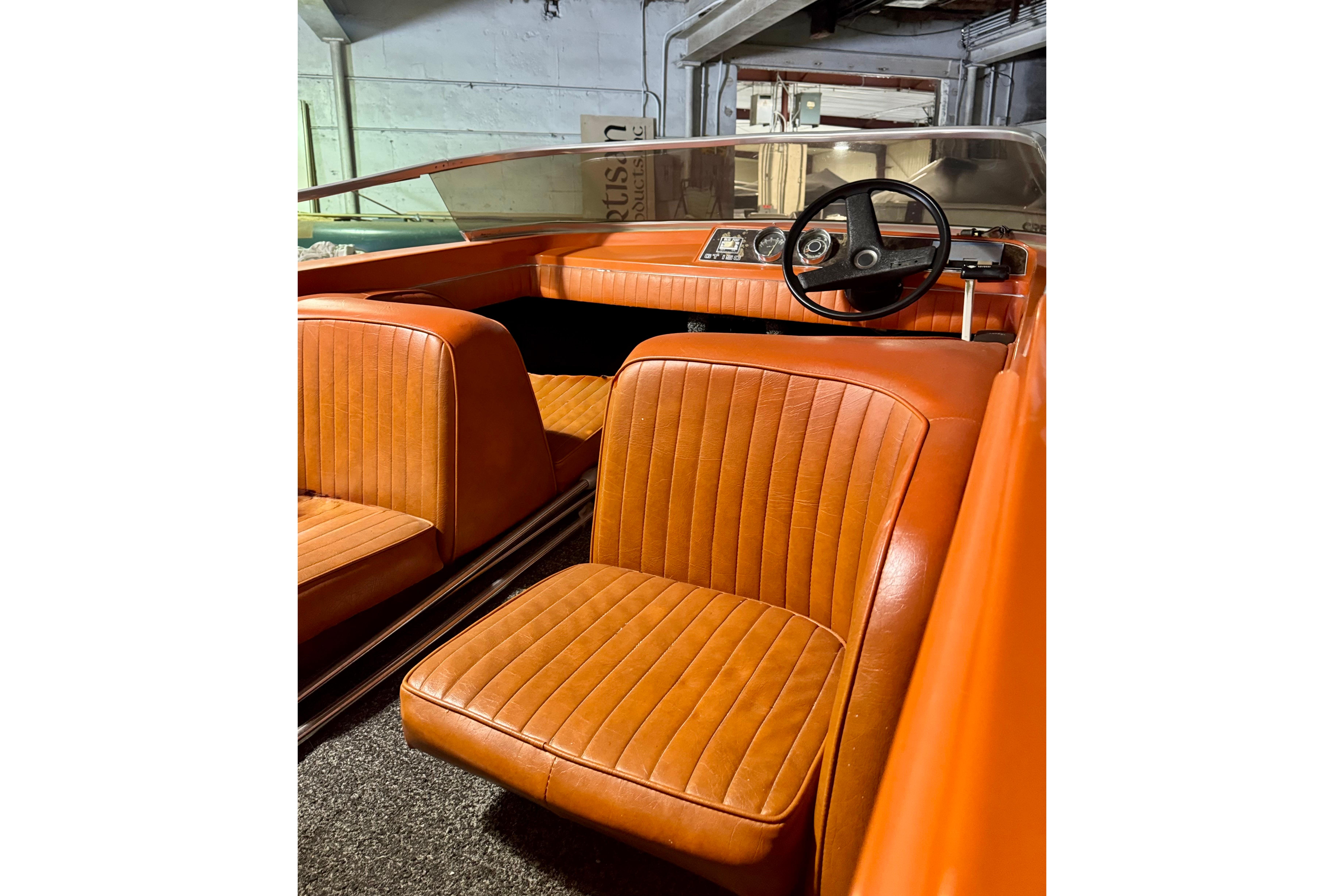 1971 Glastron/Carlson GT 15 boat interior with orange seats and classic steering wheel.