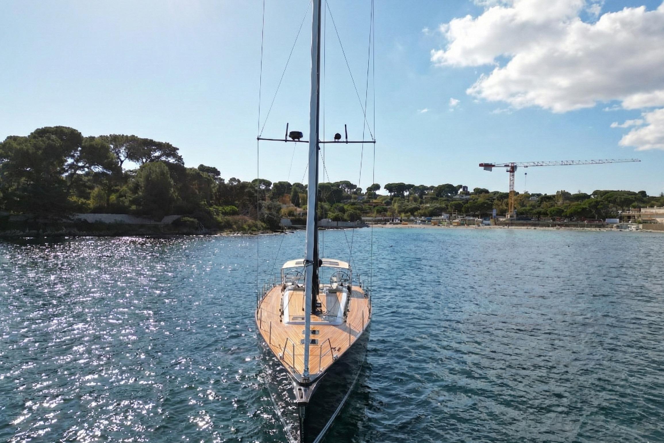 2022 Solaris 55 yacht sailing in a scenic coastal area with clear skies.