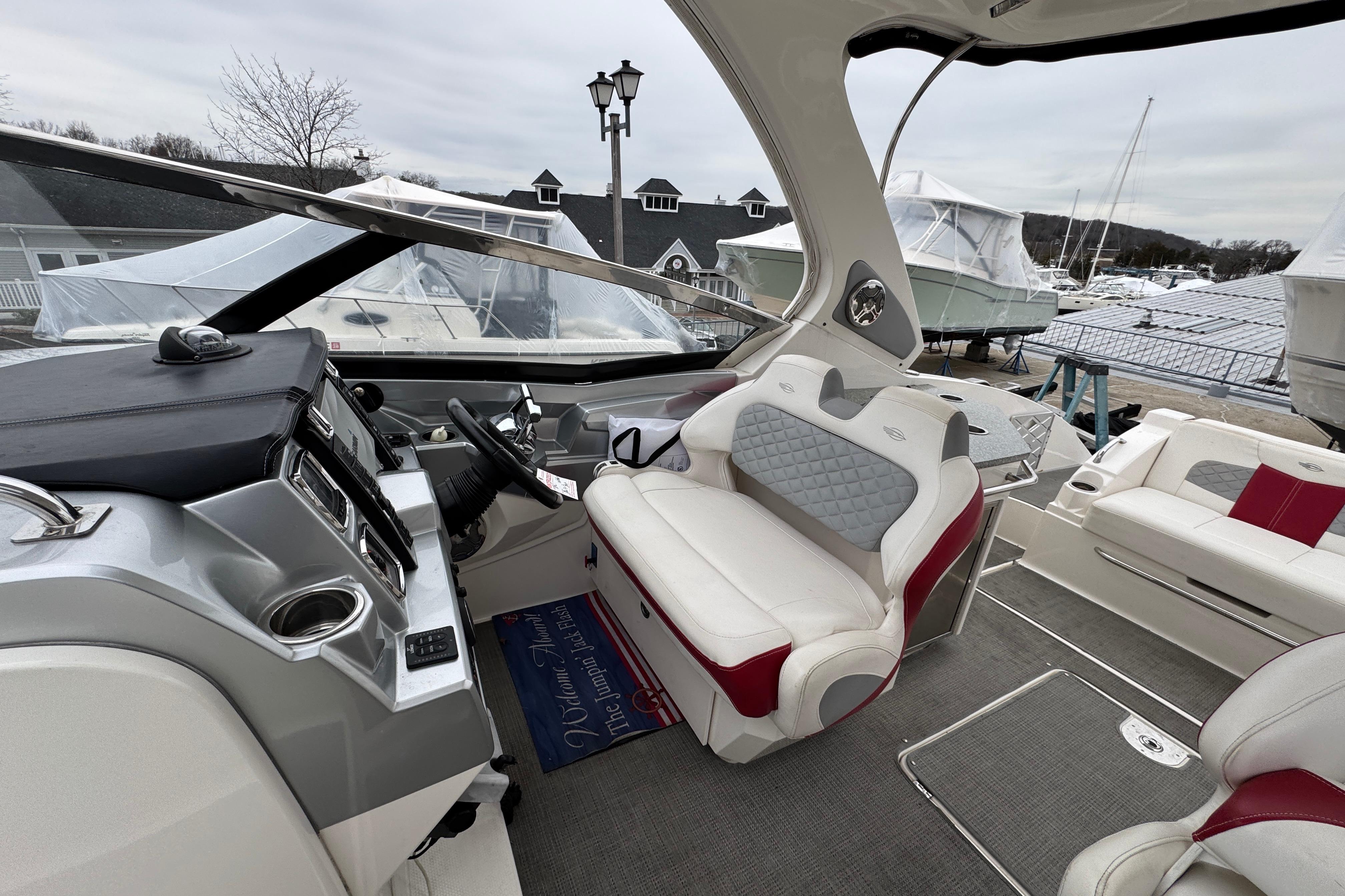 2012 Chaparral 327 SSX boat interior with modern dashboard and plush seating at a marina.