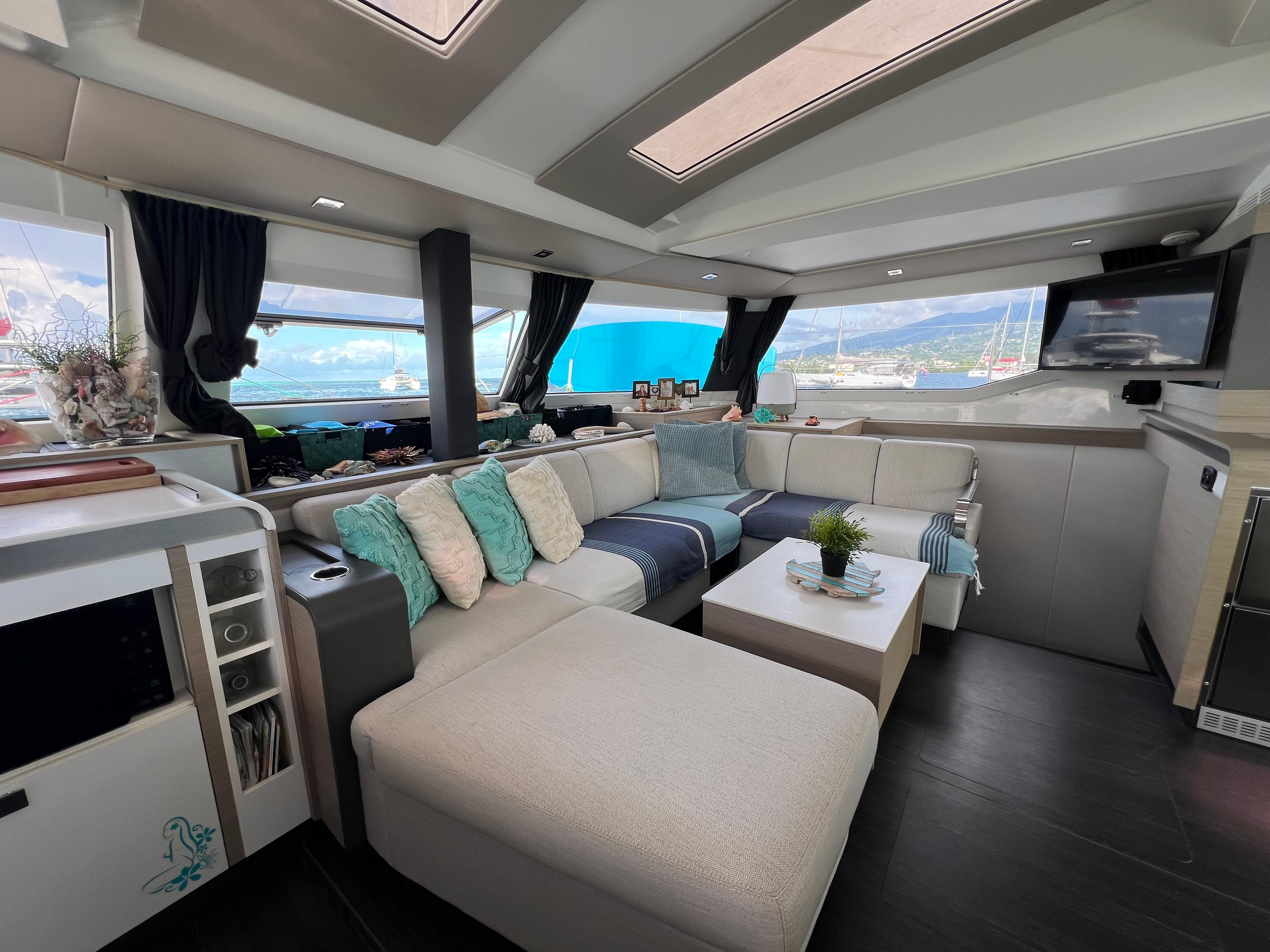 Luxurious interior of 2022 Fountaine Pajot Elba 45 catamaran with modern seating and decor.