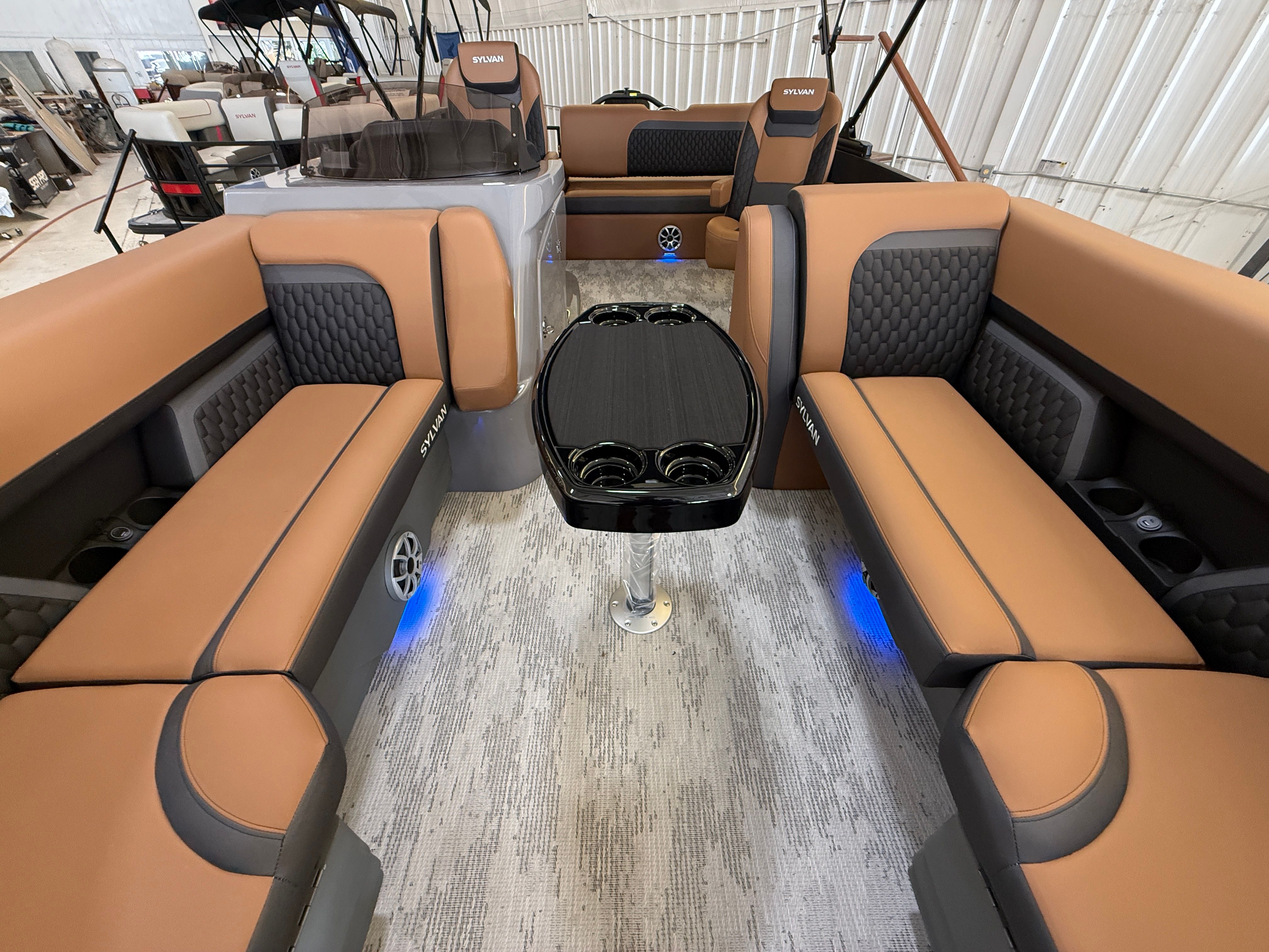 Interior of a 2026 Sylvan L3 ULZ DH with luxurious seating and a central table.