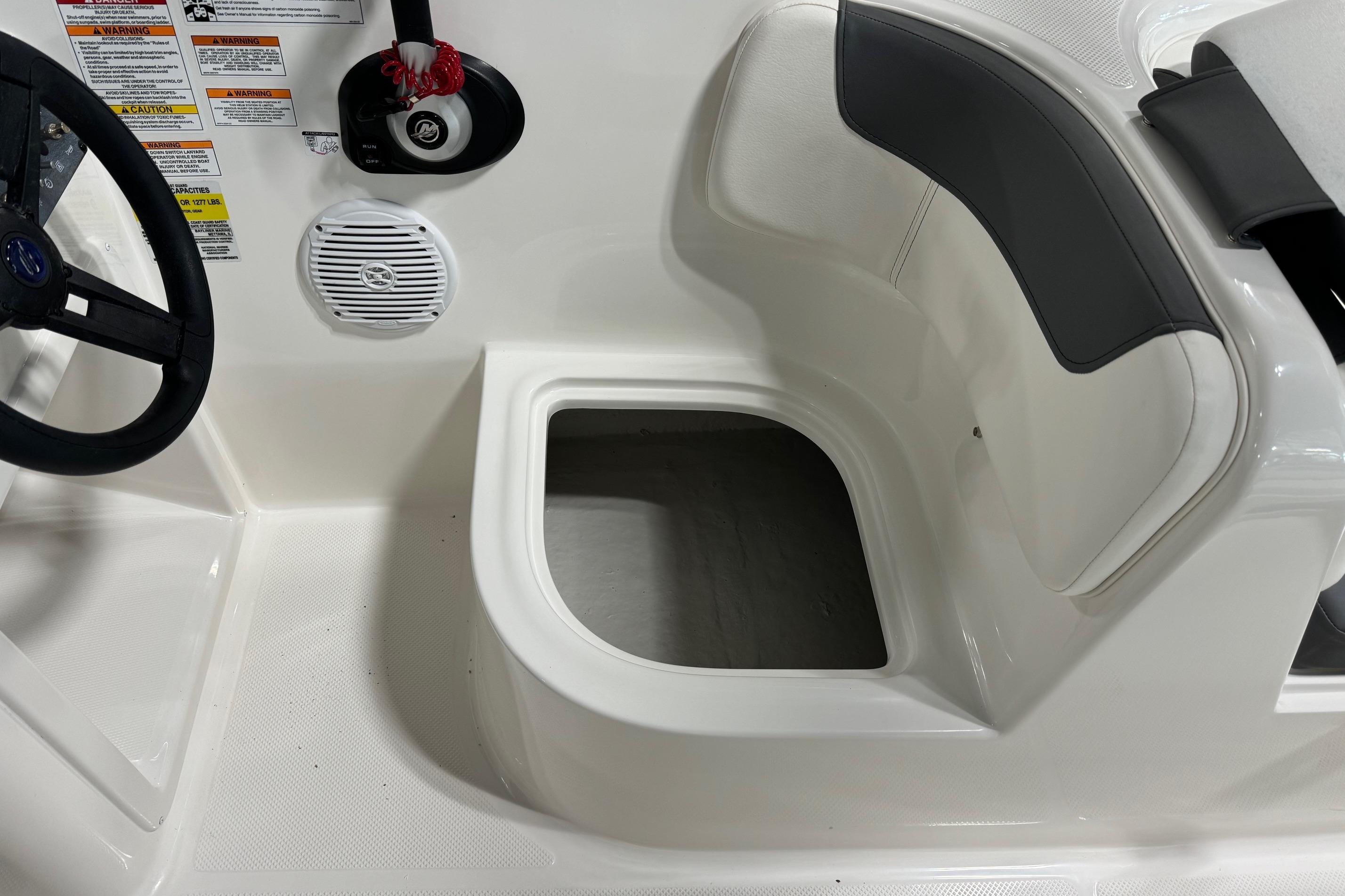 2025 Bayliner Element E18 boat interior with steering wheel and storage compartment.