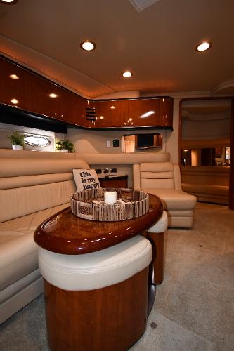 Luxurious interior of 2003 Sea Ray 460 Sundancer yacht with elegant seating and wooden finishes.