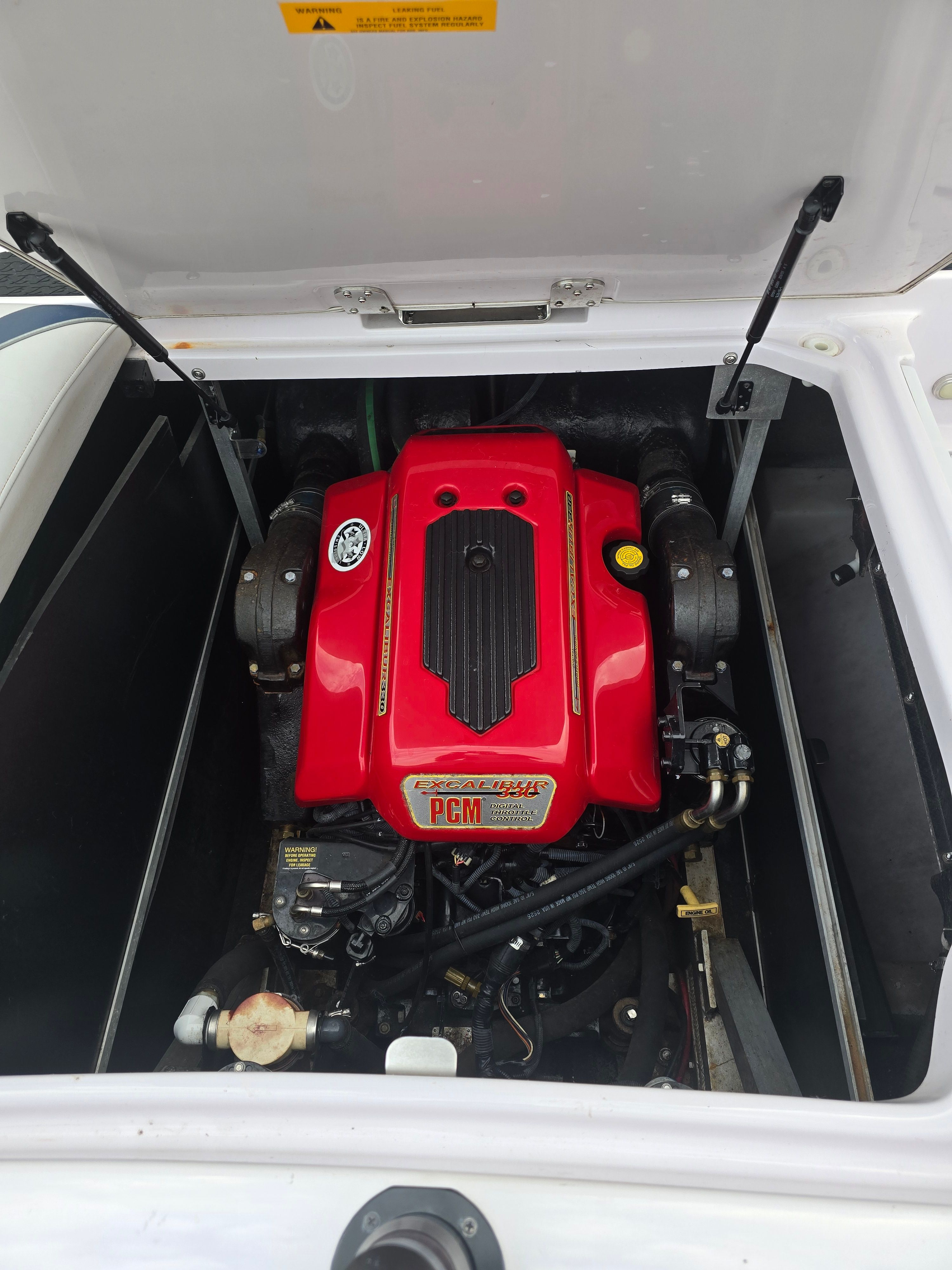 Engine compartment of a 2006 Correct Craft 228 boat with red PCM engine.