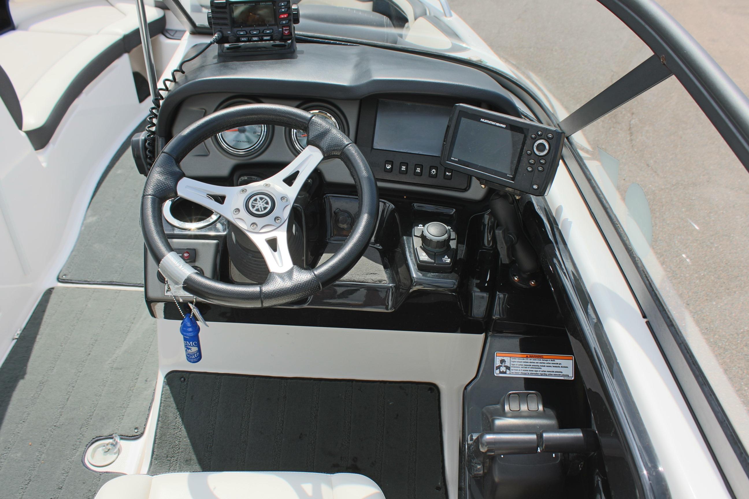 2016 Yamaha Boats 242 Limited S dashboard with steering wheel and navigation equipment.