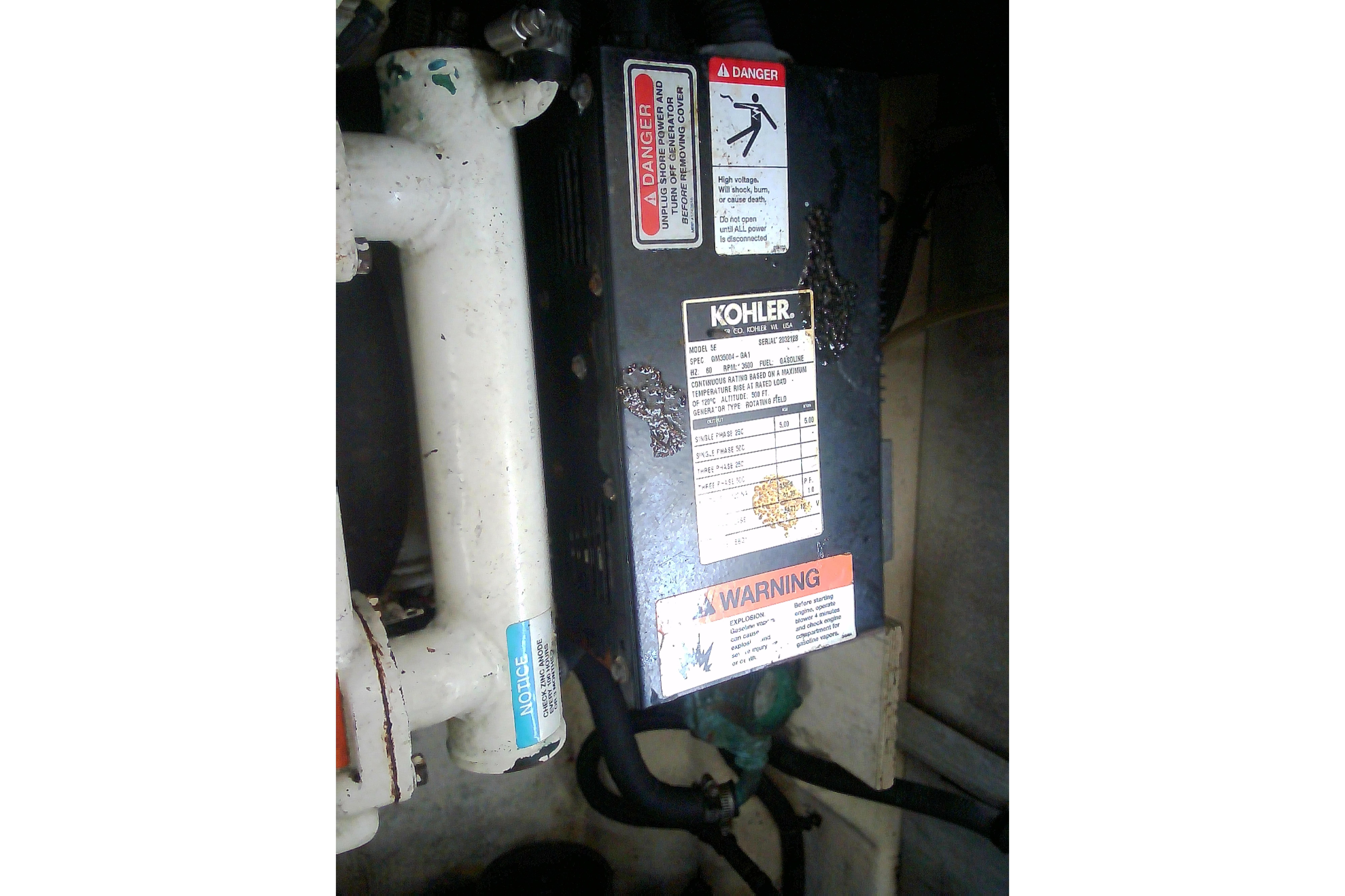 Engine compartment of 2005 Sea Ray 300 Sundancer with Kohler generator and warning labels.