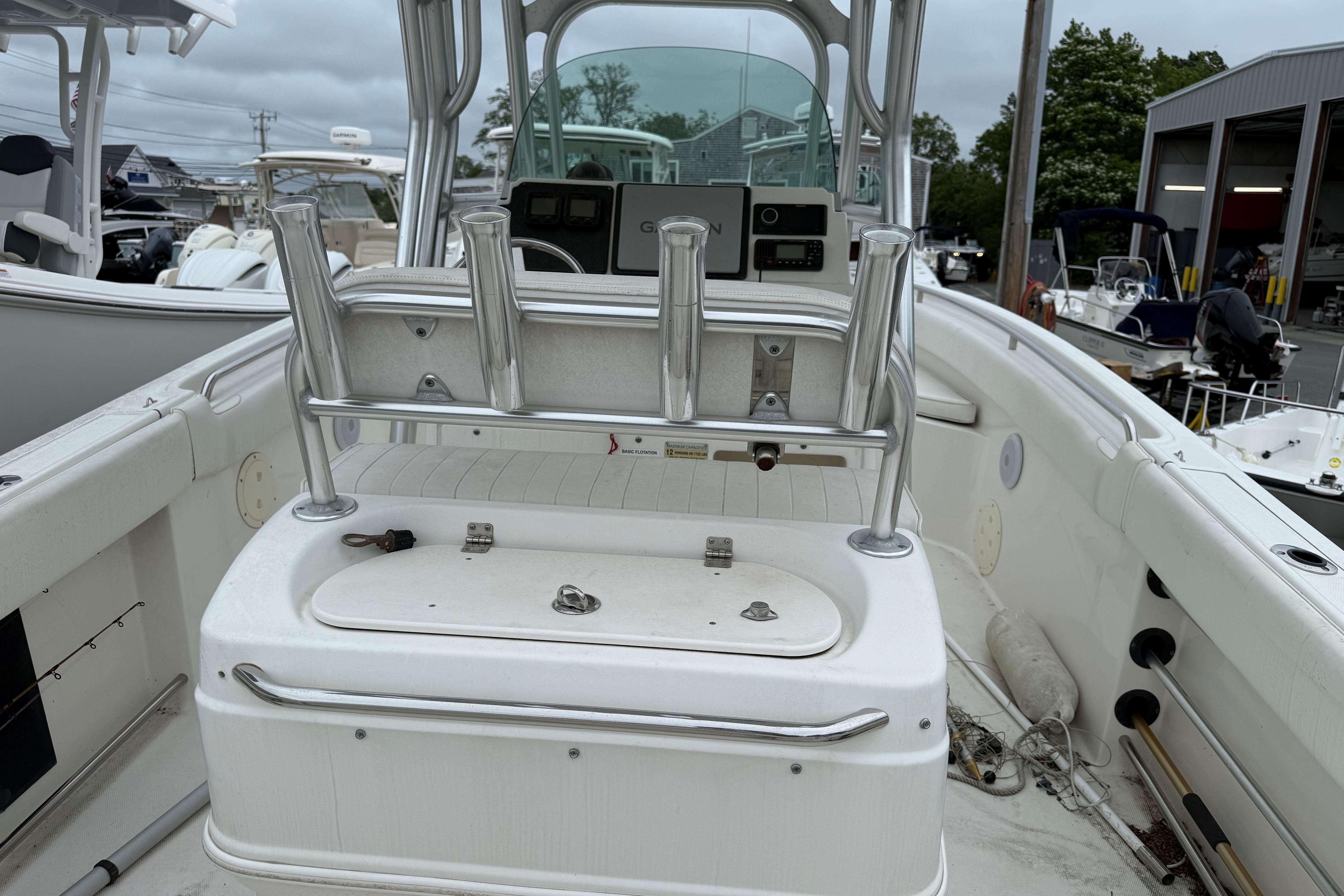 2009 Robalo R240 Center Console boat interior with rod holders and storage compartment.
