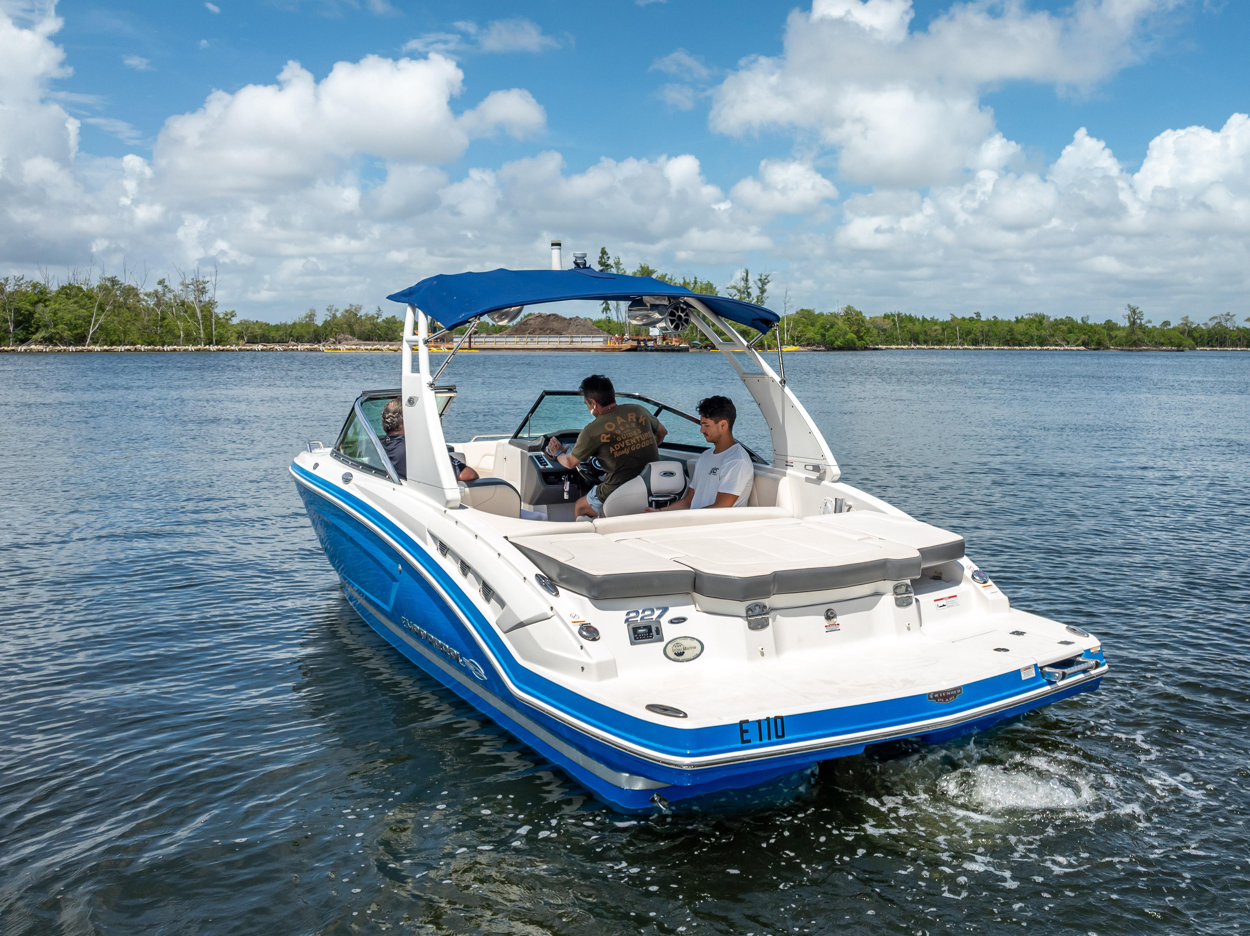 2017 Chaparral 227 SSX boat cruising on a sunny day with passengers onboard.