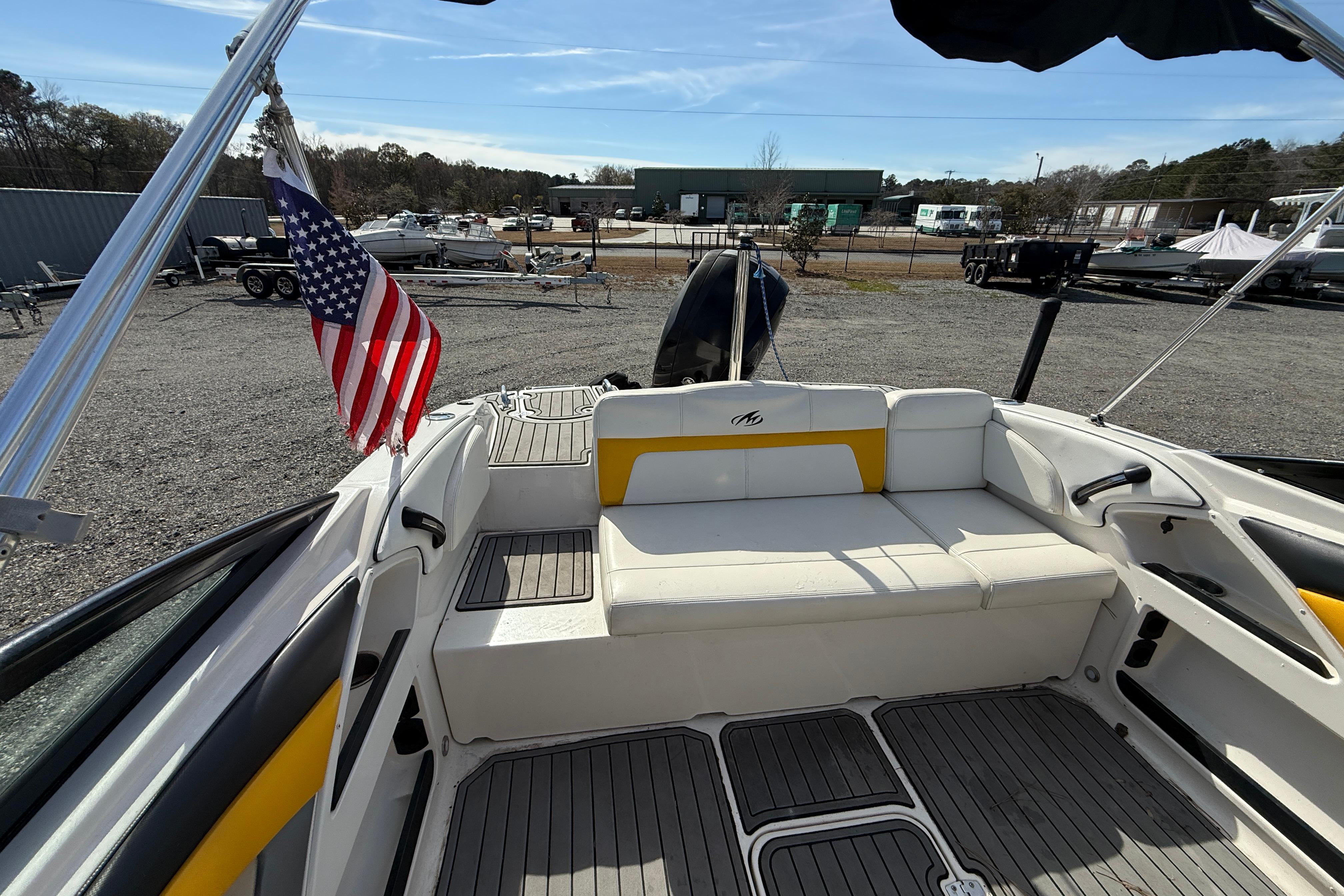 2014 Monterey 197 Blackfin boat interior with American flag, docked outdoors.