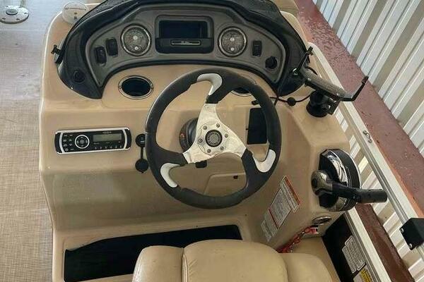 2019 Sun Tracker SportFish 22 DLX boat dashboard with steering wheel and controls.