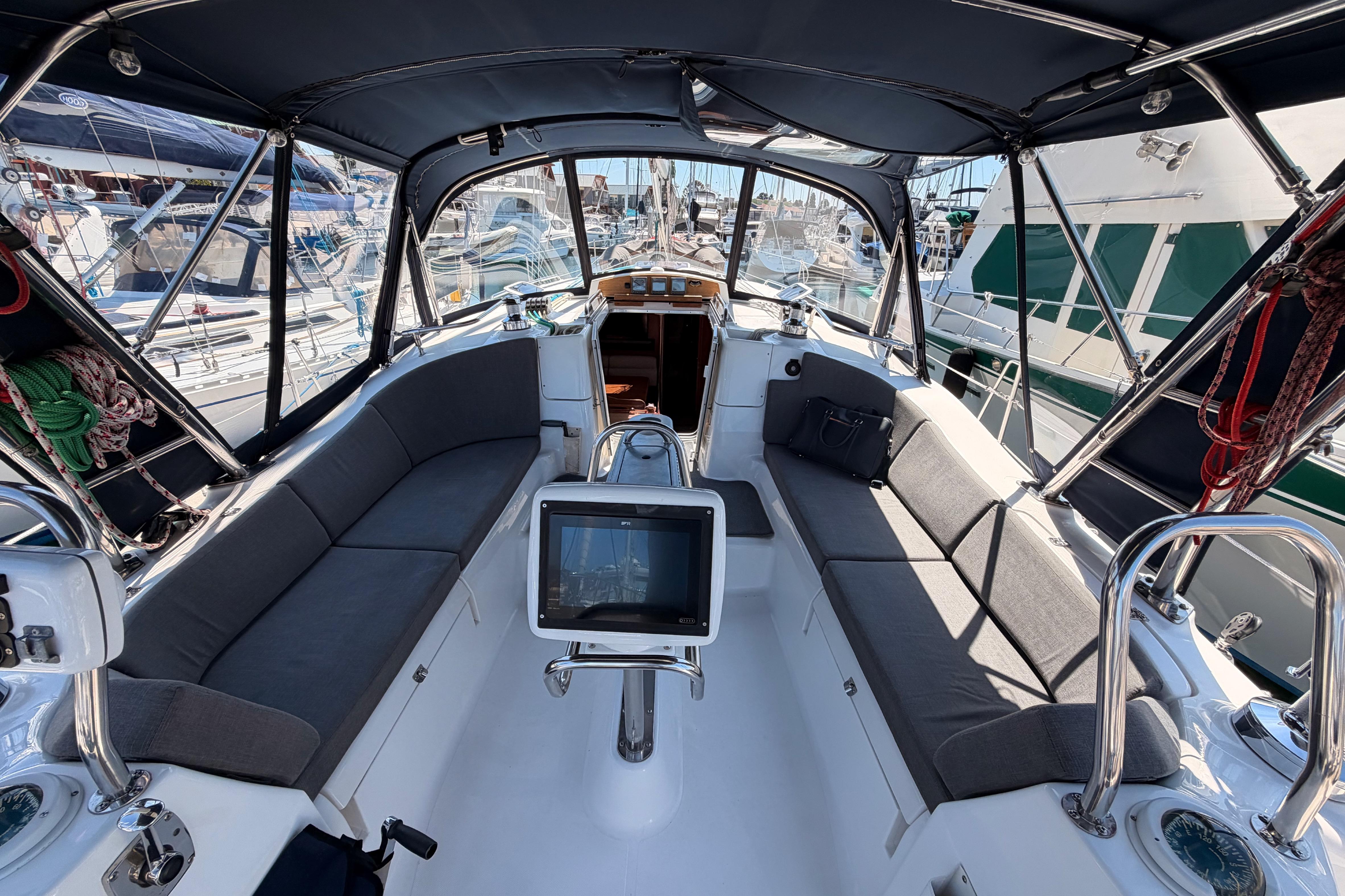 2008 Hunter 45 Deck Salon yacht cockpit with seating and navigation equipment in marina.
