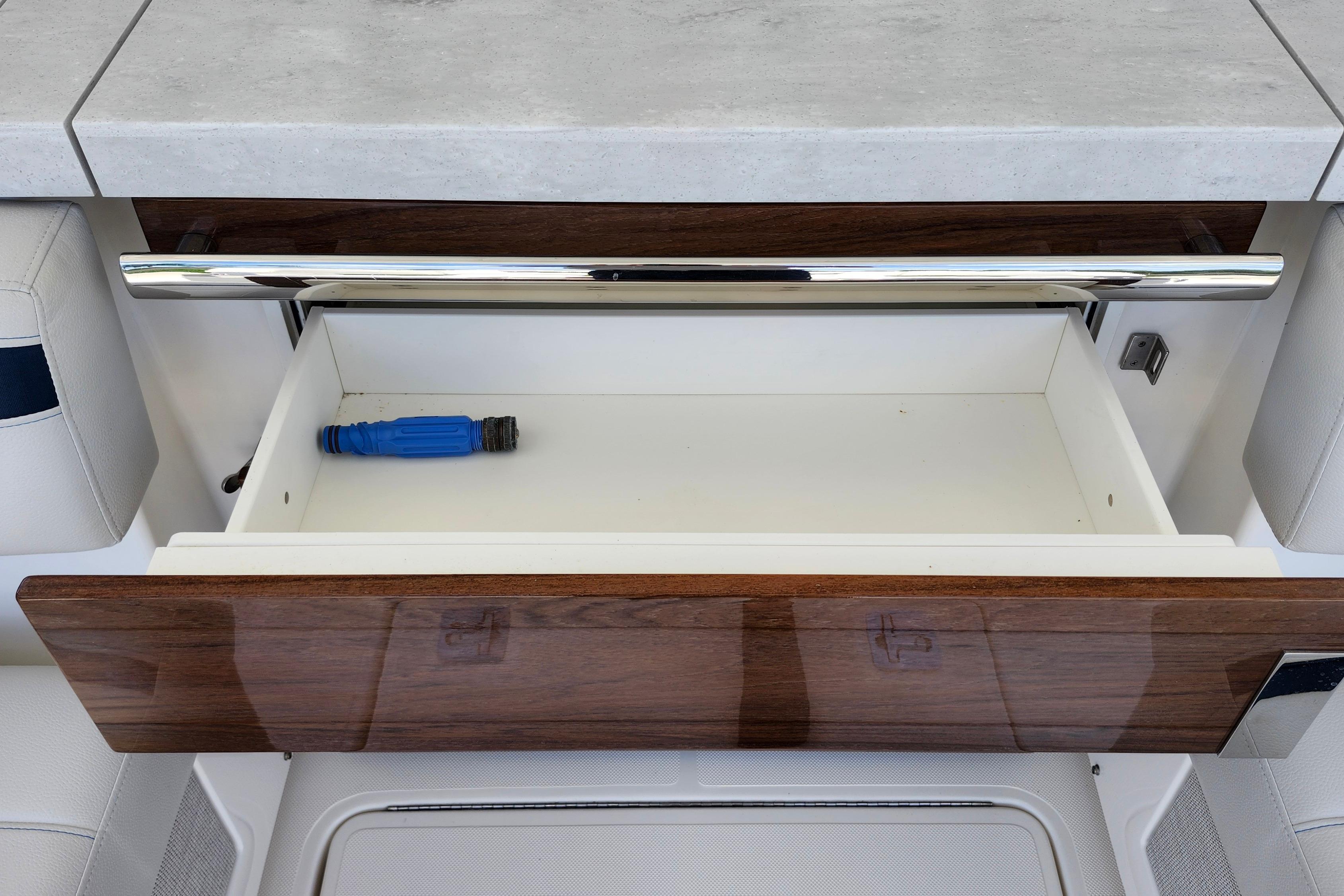 Open drawer in 2022 Tiara Yachts 38 LS, featuring sleek design and chrome handle.