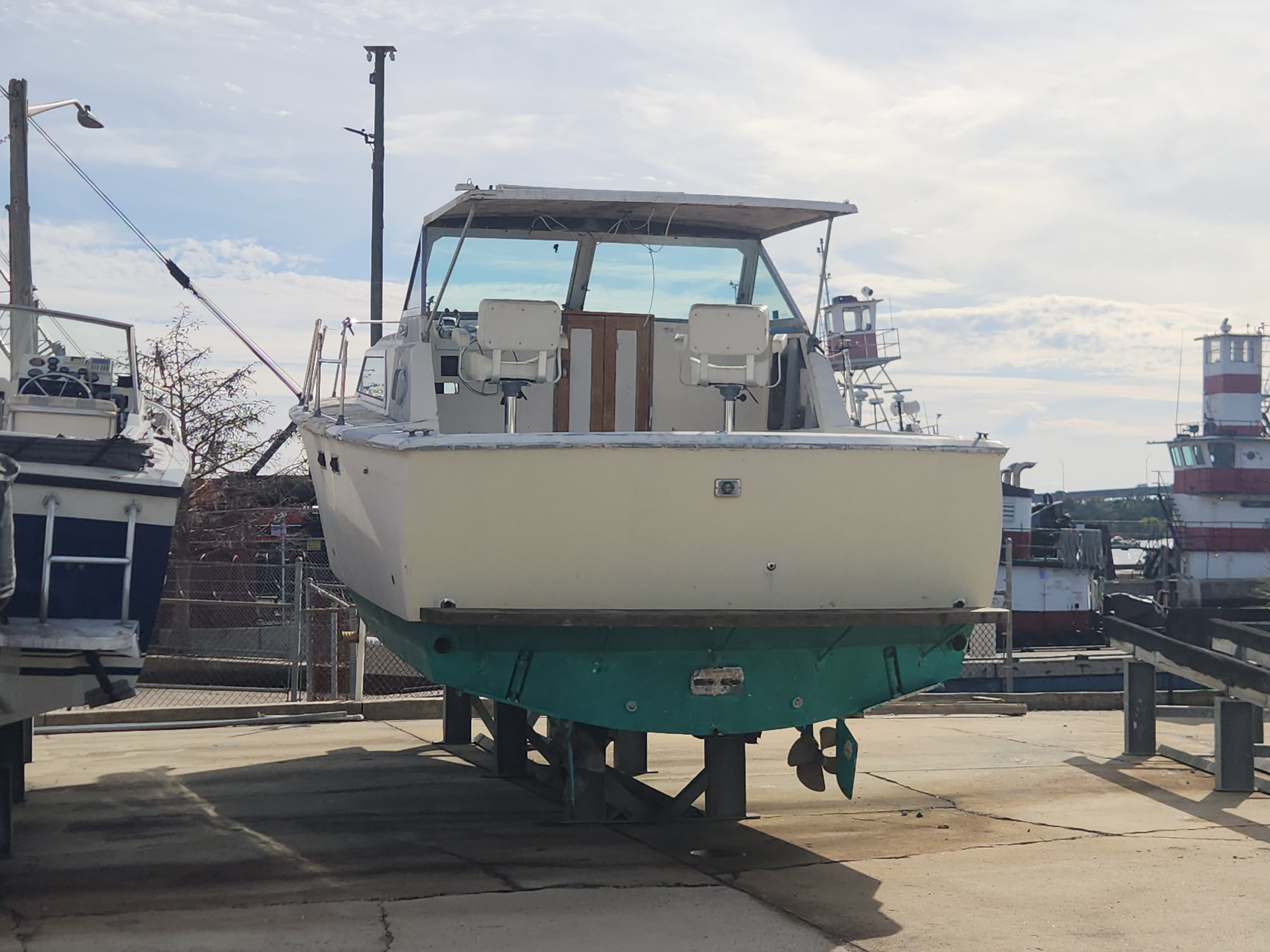 1967 Hatteras 28ft boat on dry dock in harbor.