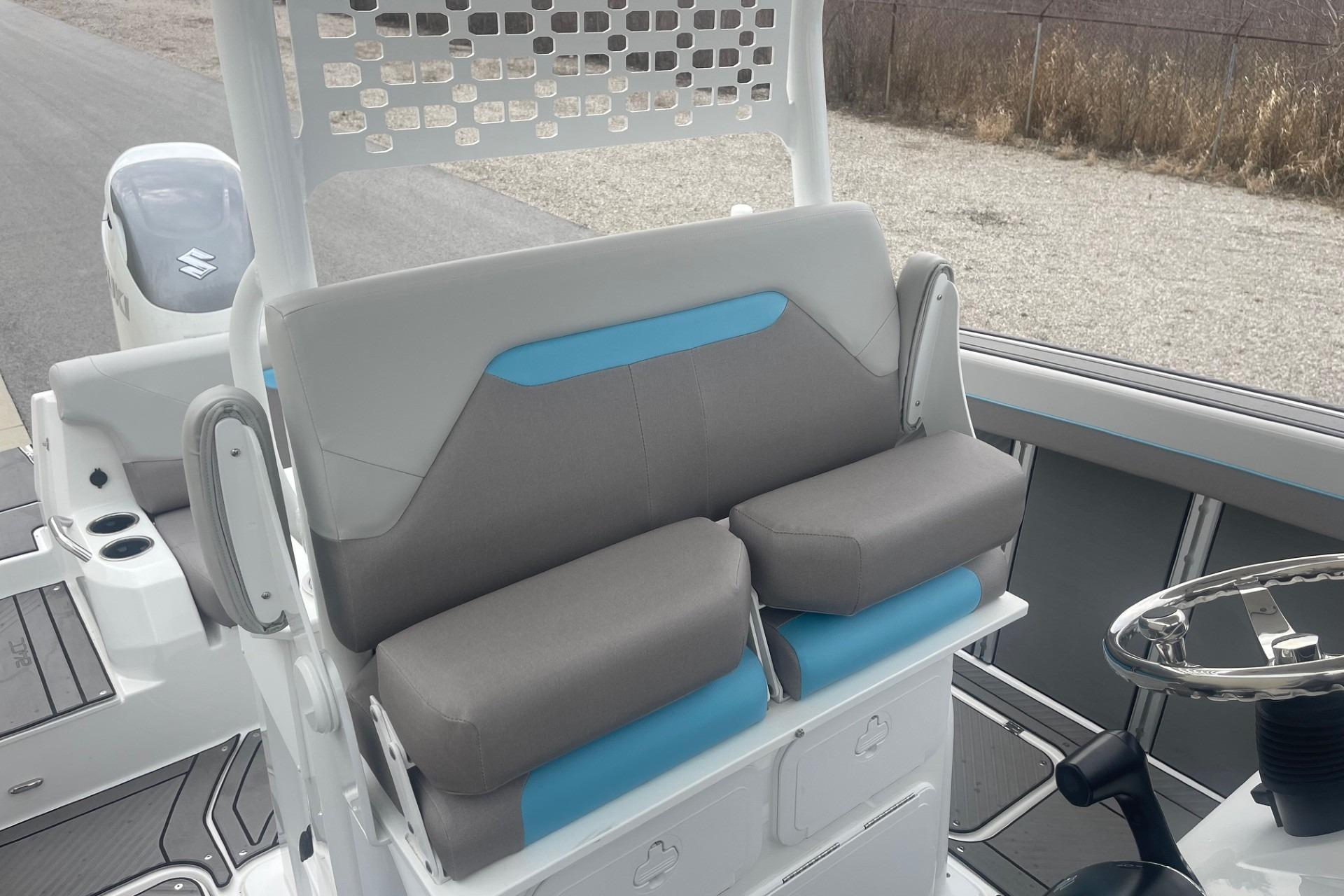 2025 Hurricane Center Console 24 OB boat interior with cushioned seating and steering wheel.