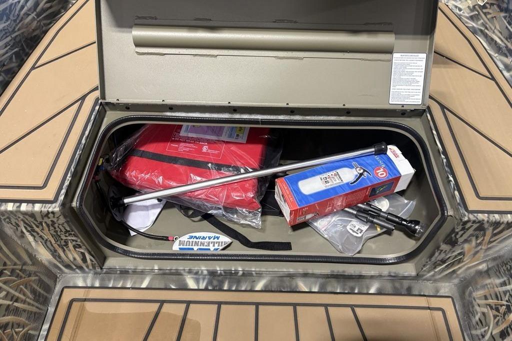 Storage compartment of 2026 Tracker Grizzly 1650 T Prairie Wings Edition with safety gear.