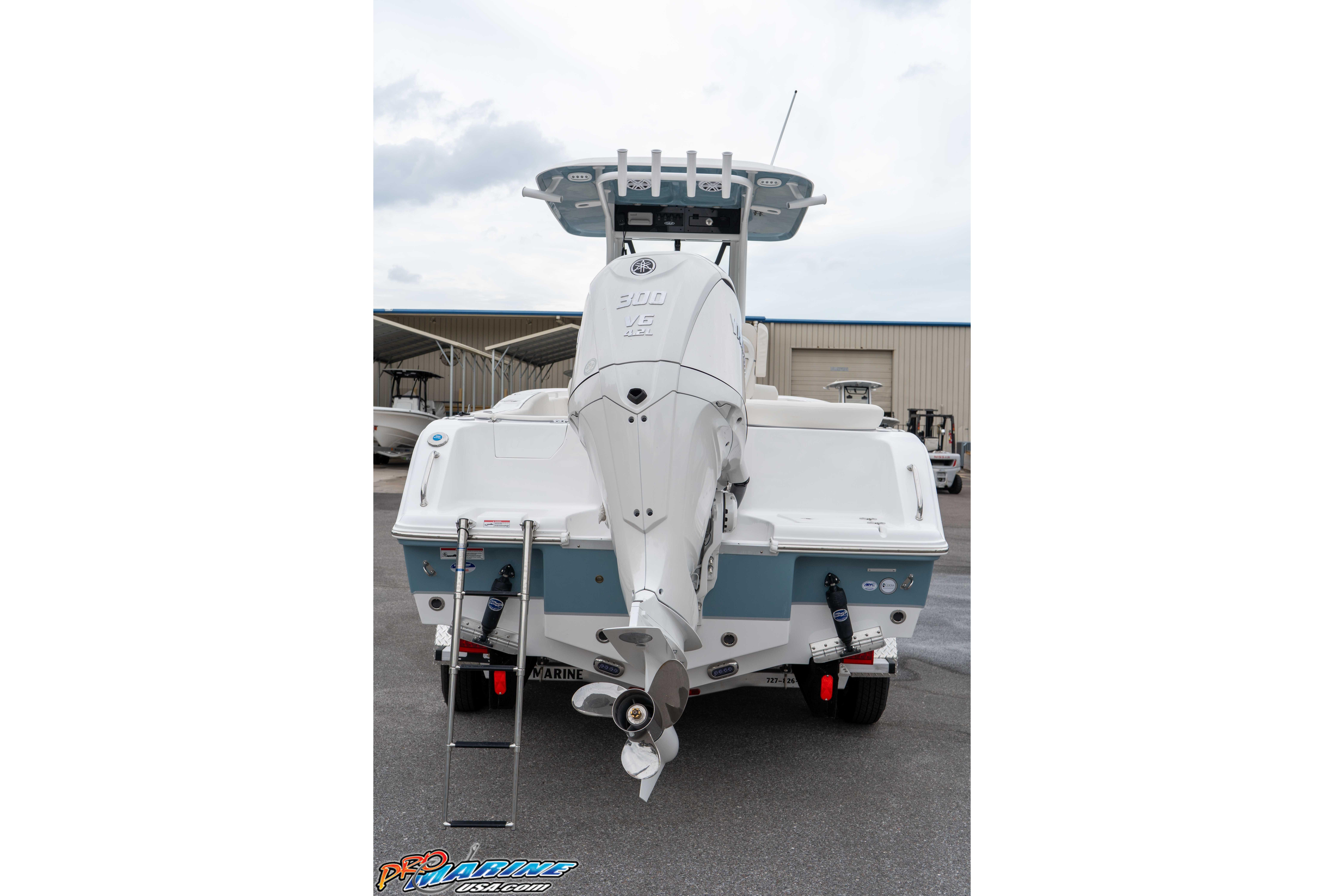 2026 Sea Hunt Ultra 245 SE boat rear view with outboard motor and ladder.