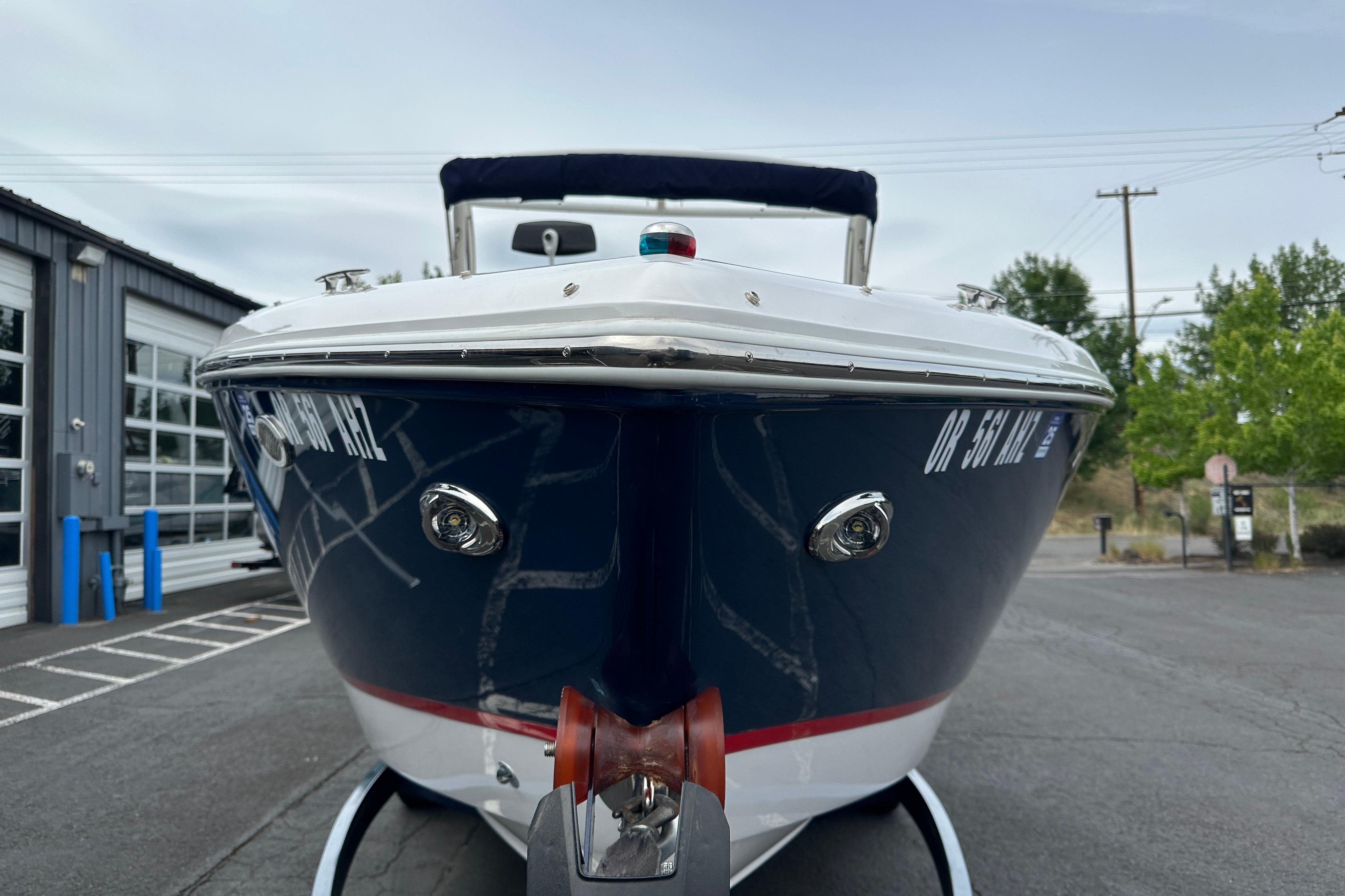 2019 Cobalt R5 boat on trailer, parked outdoors near a garage.