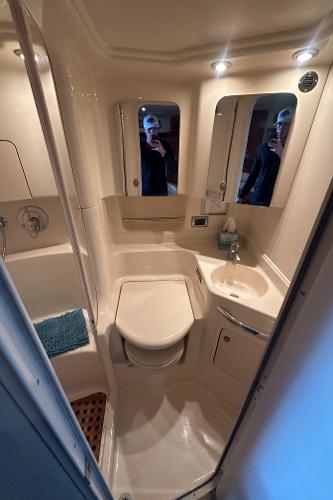2004 Sea Ray 380 Sundancer bathroom with shower, sink, and toilet.
