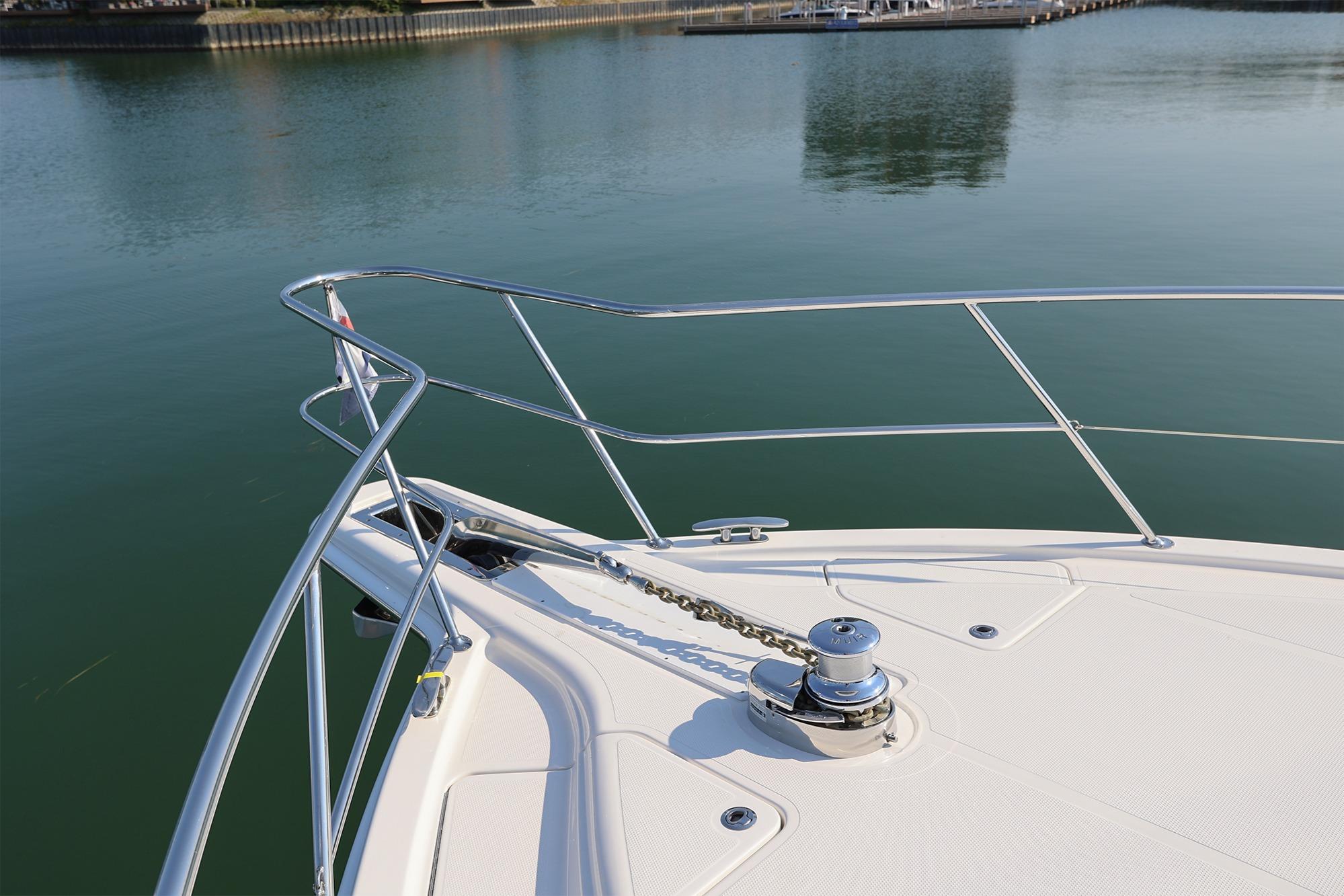 Bow of 2016 Riviera 525 SUV yacht on calm water.