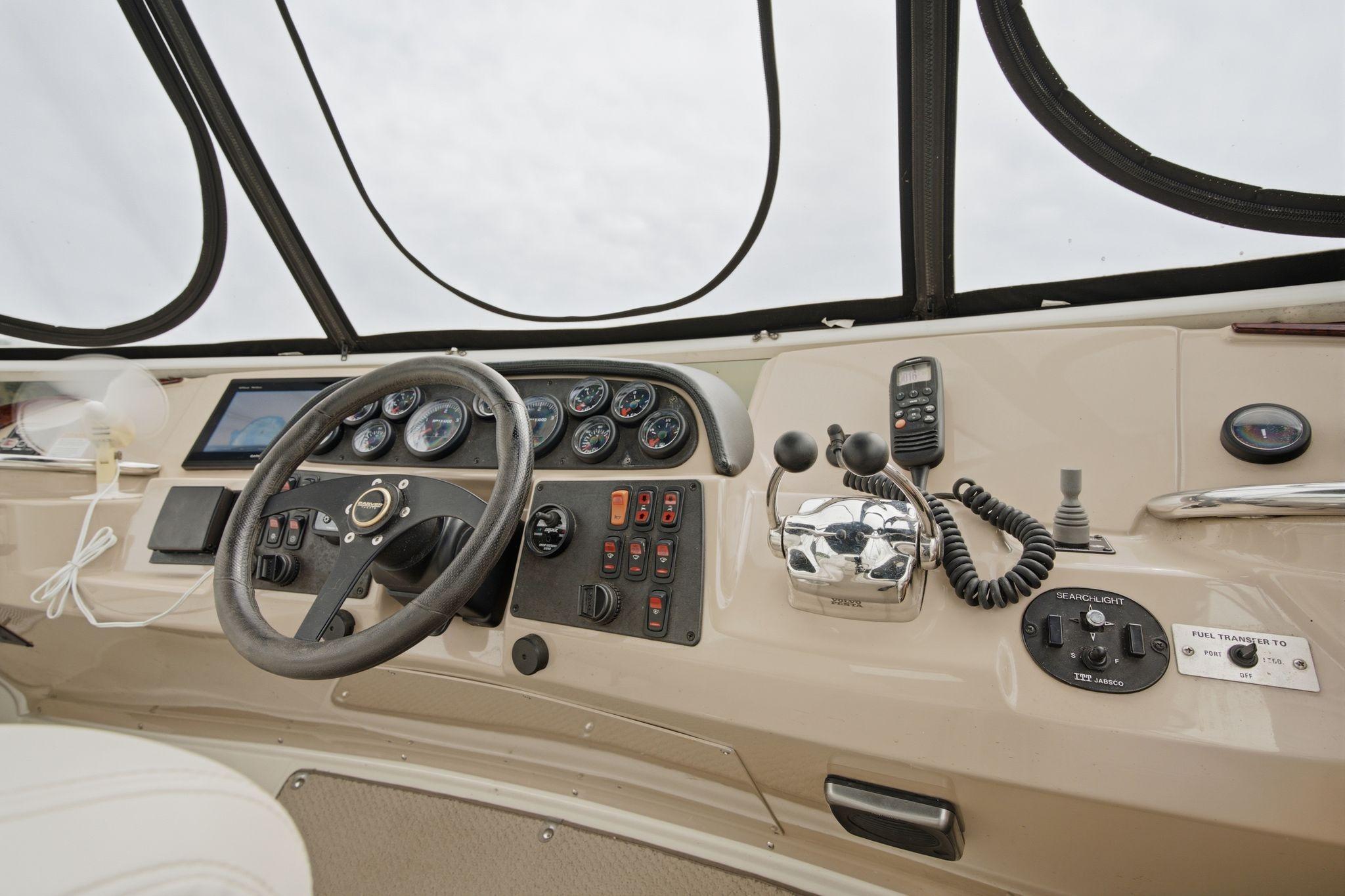 2005 Carver 39 Motor Yacht helm with steering wheel, gauges, and controls.