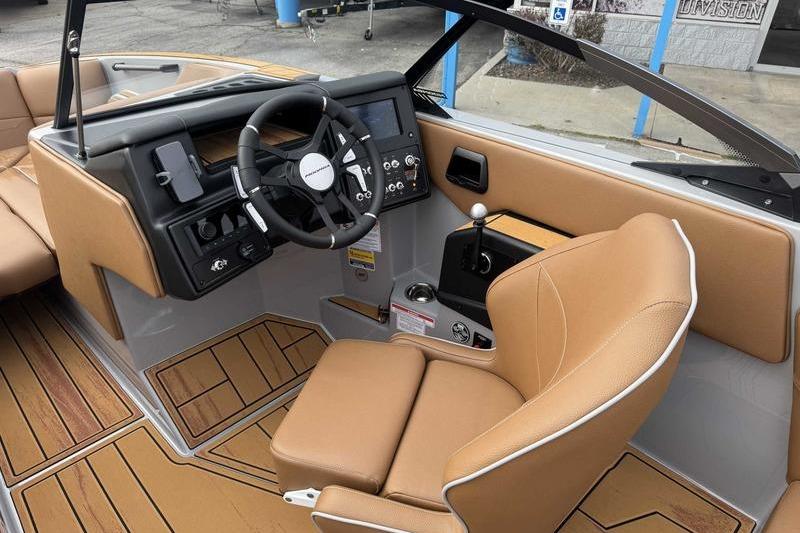 2026 Moomba Max boat interior with tan leather seats and modern dashboard controls.
