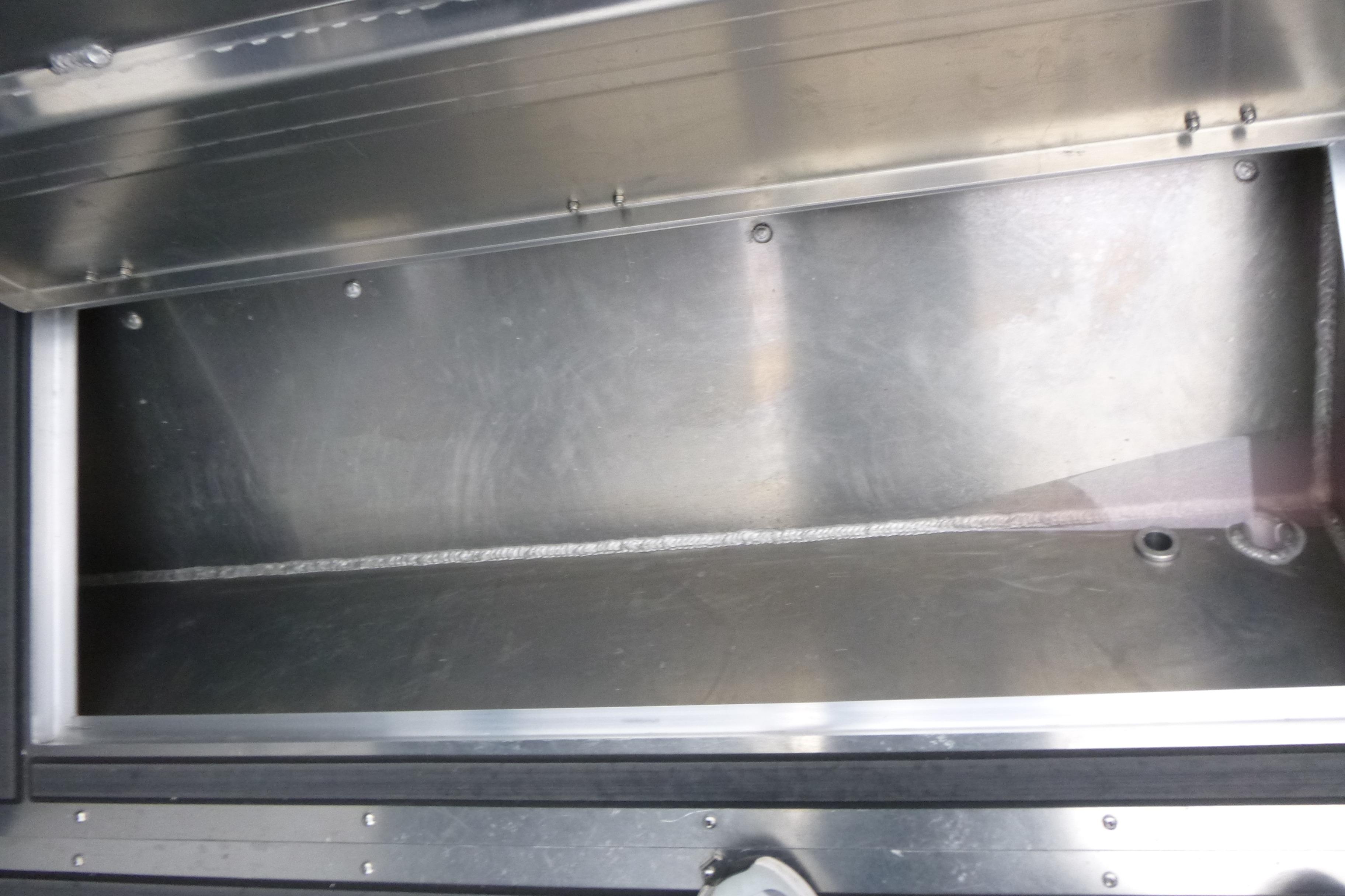 Storage compartment of 2026 KingFisher 25 XAC boat, featuring durable metal construction.