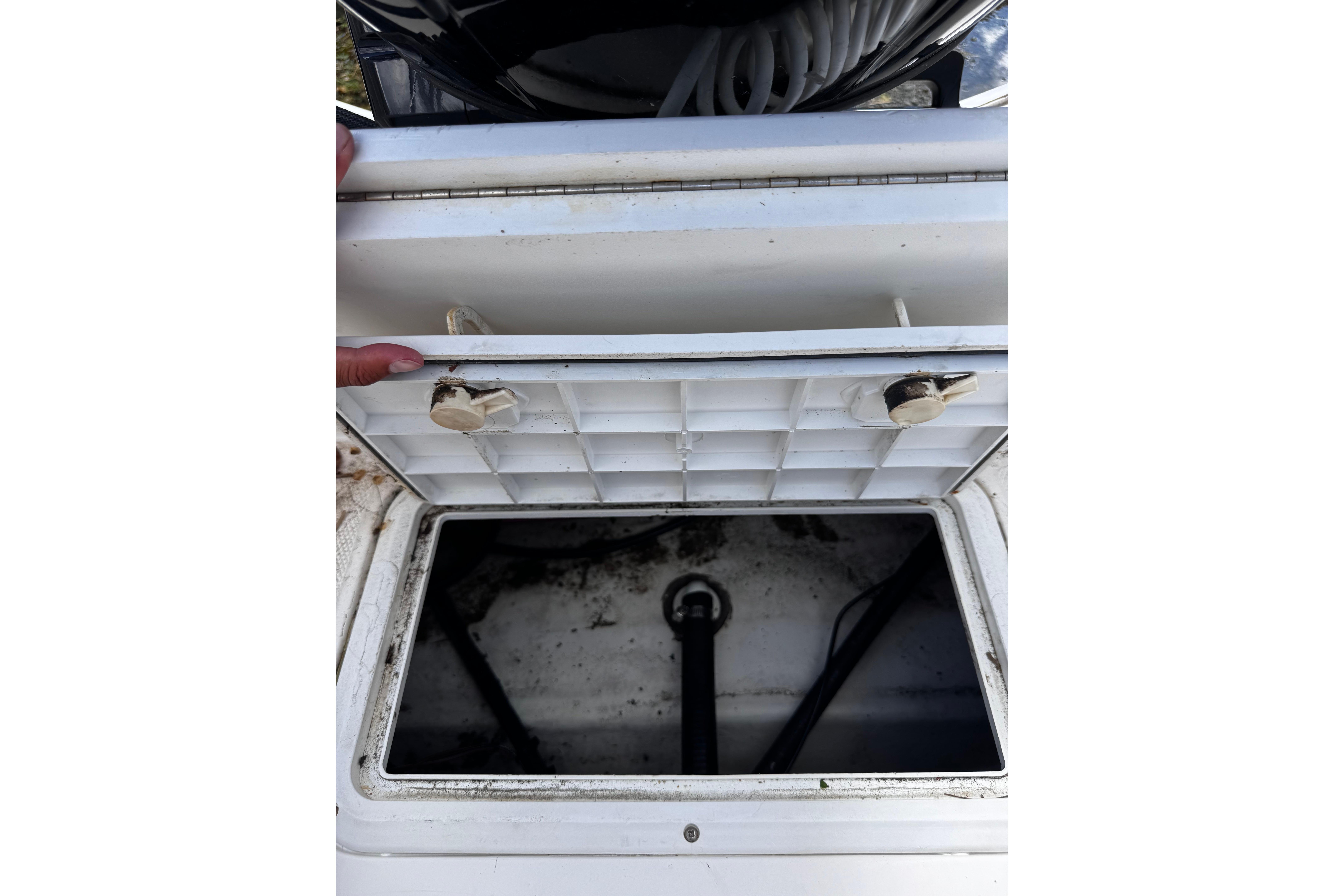 Open storage compartment on a 2003 Palm Beach 2200 Dual Console boat.