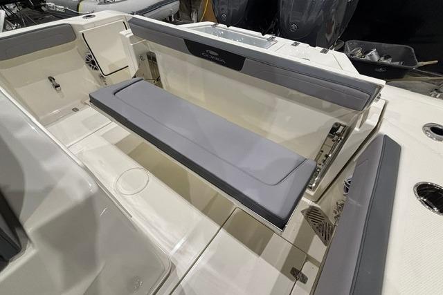 2026 Cobia 245 Center Console boat interior with foldable seating and storage.