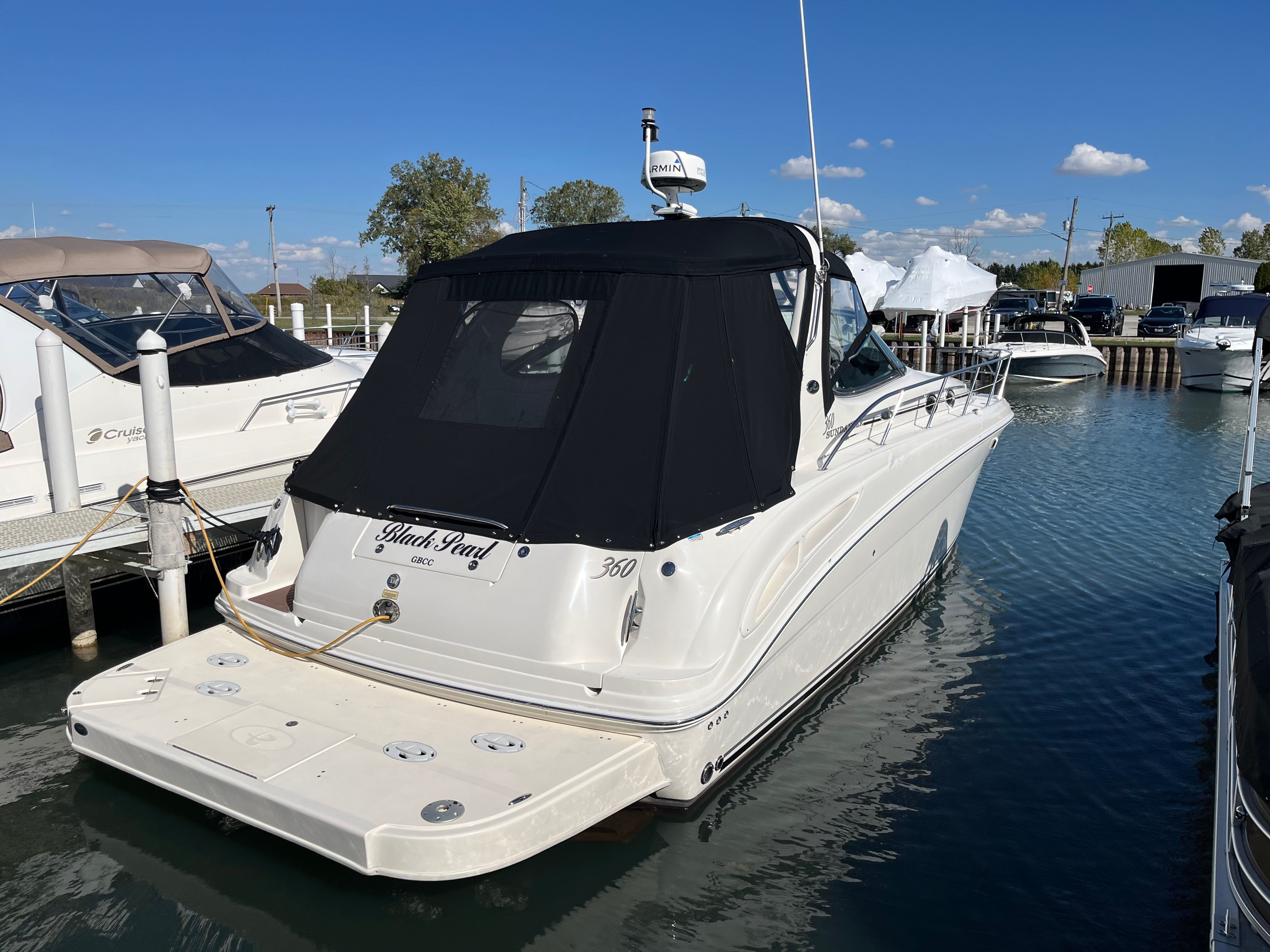 2005 Sea Ray Sundancer yacht docked in marina, sunny day.