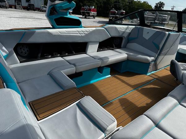 2022 Nautique S23 boat interior with modern seating and teak flooring.