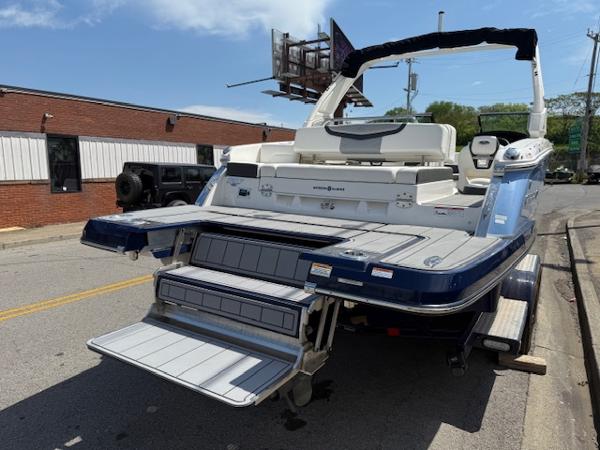 2023 Chaparral 267 SSX boat with extended swim platform on a street.