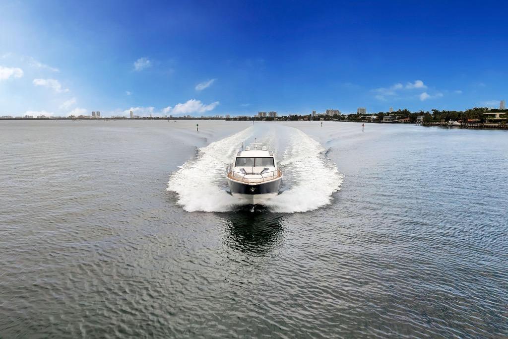 Fairline Targa 58 yacht cruising on open water, 2012 model, under clear blue skies.