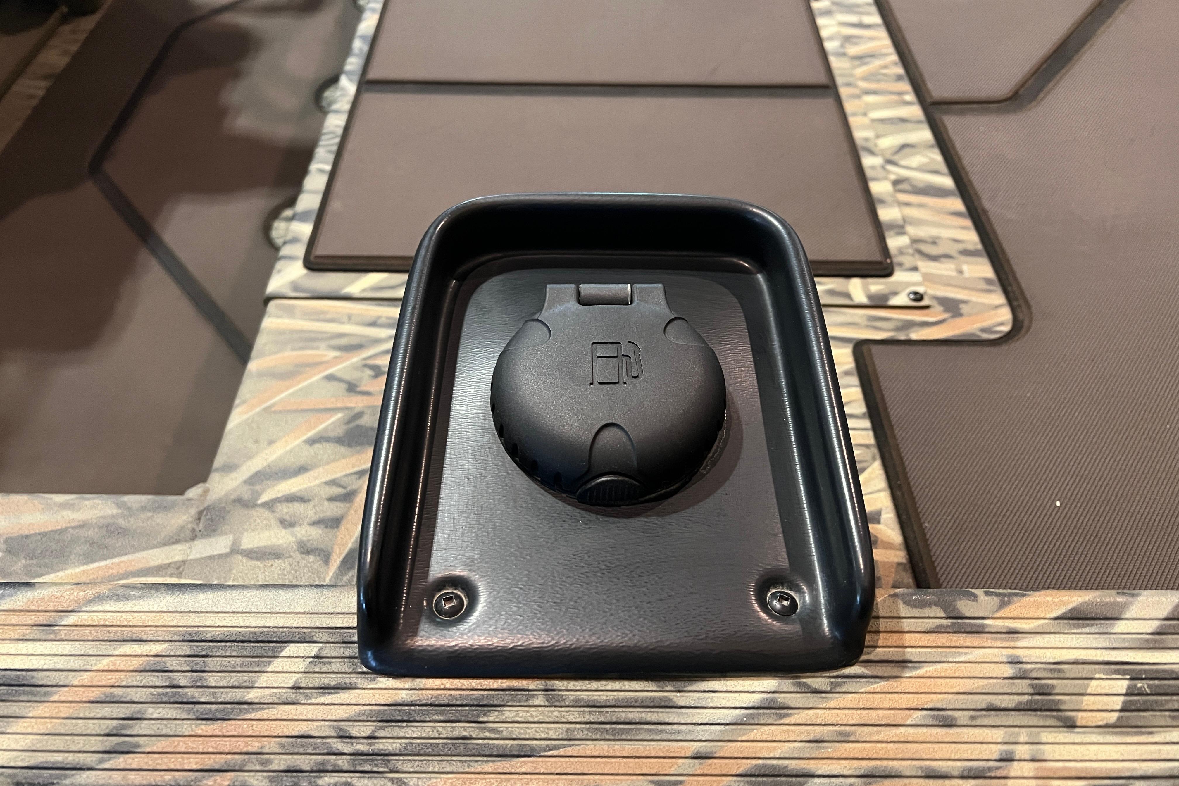 Fuel cap on 2026 Tracker Grizzly 1860 CC boat deck, camo pattern.