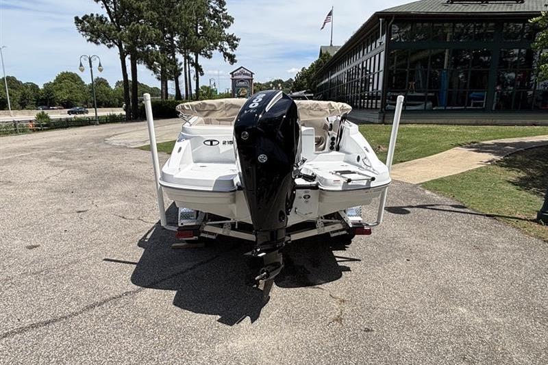 2026 Tahoe 2150 boat with outboard motor parked outdoors.