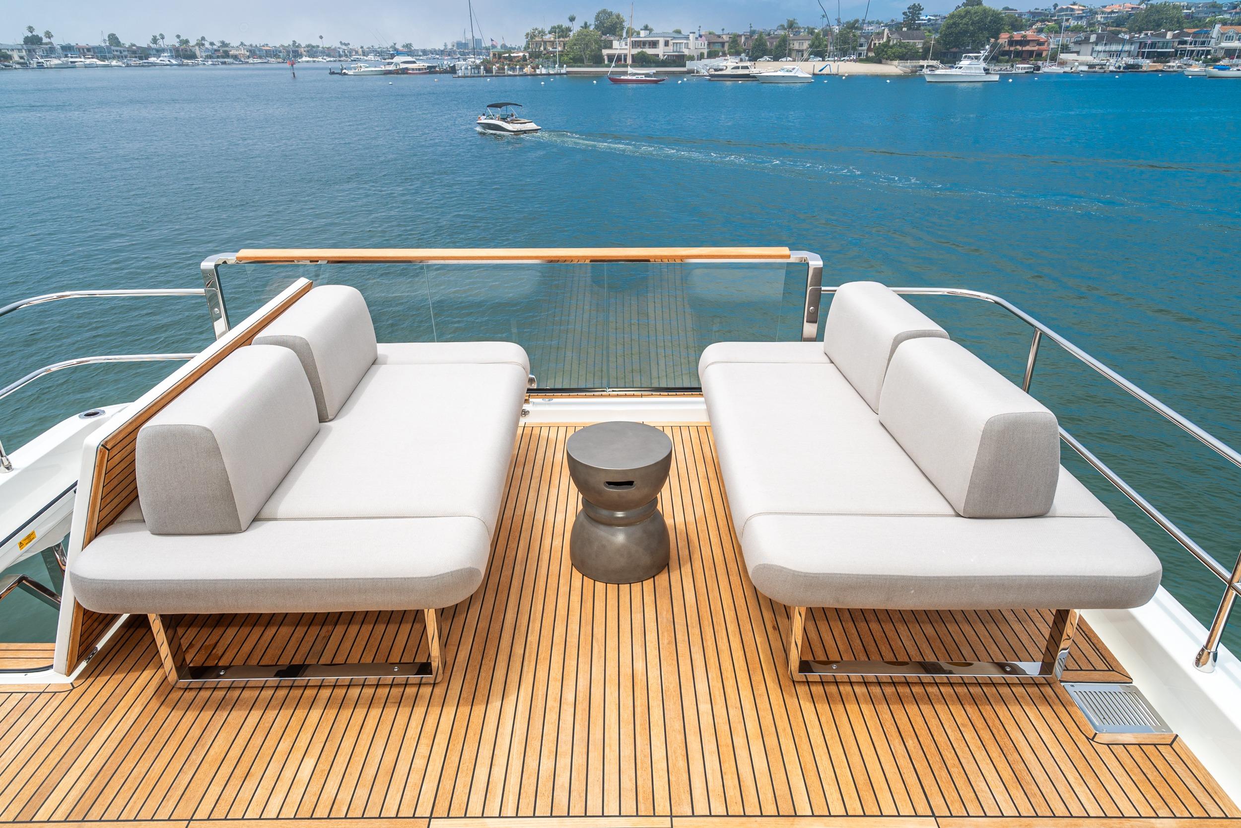 Luxurious 2024 Prestige X60 yacht deck with modern seating overlooking serene waters.