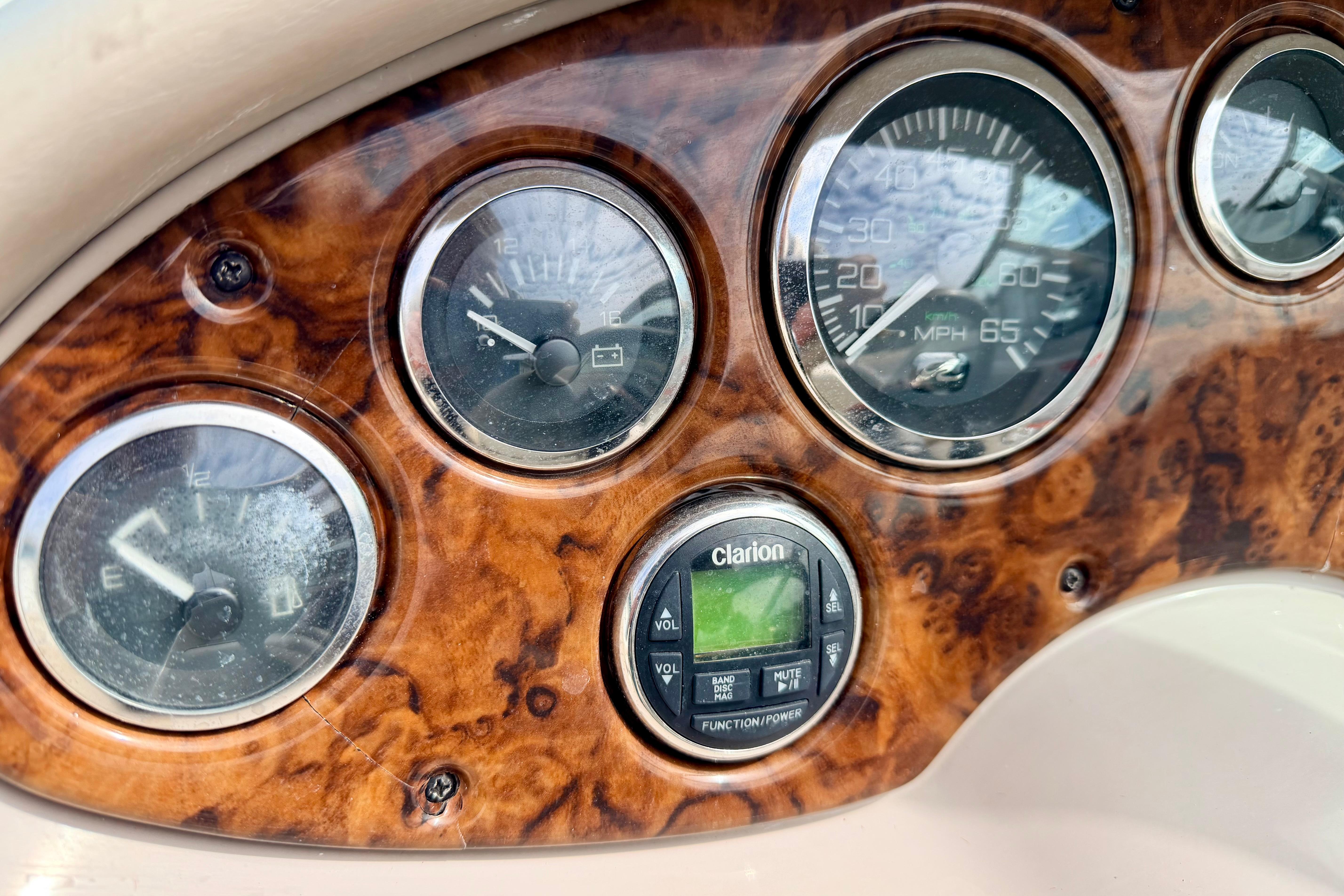 Dashboard of 2003 Sea Ray 200 Sundeck with gauges and Clarion audio system.