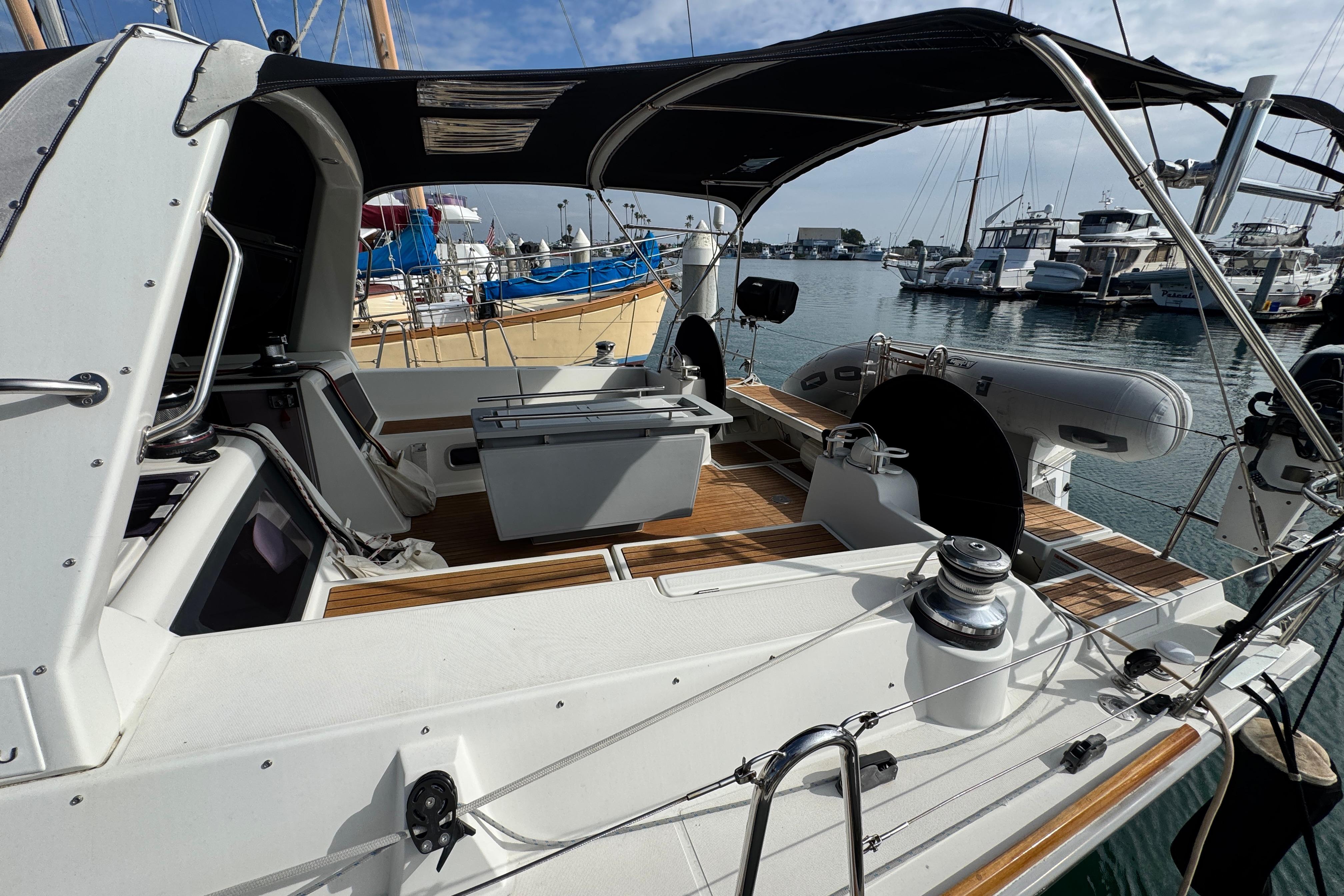 2016 Beneteau Oceanis 48 sailboat cockpit with canopy, docked in a marina.