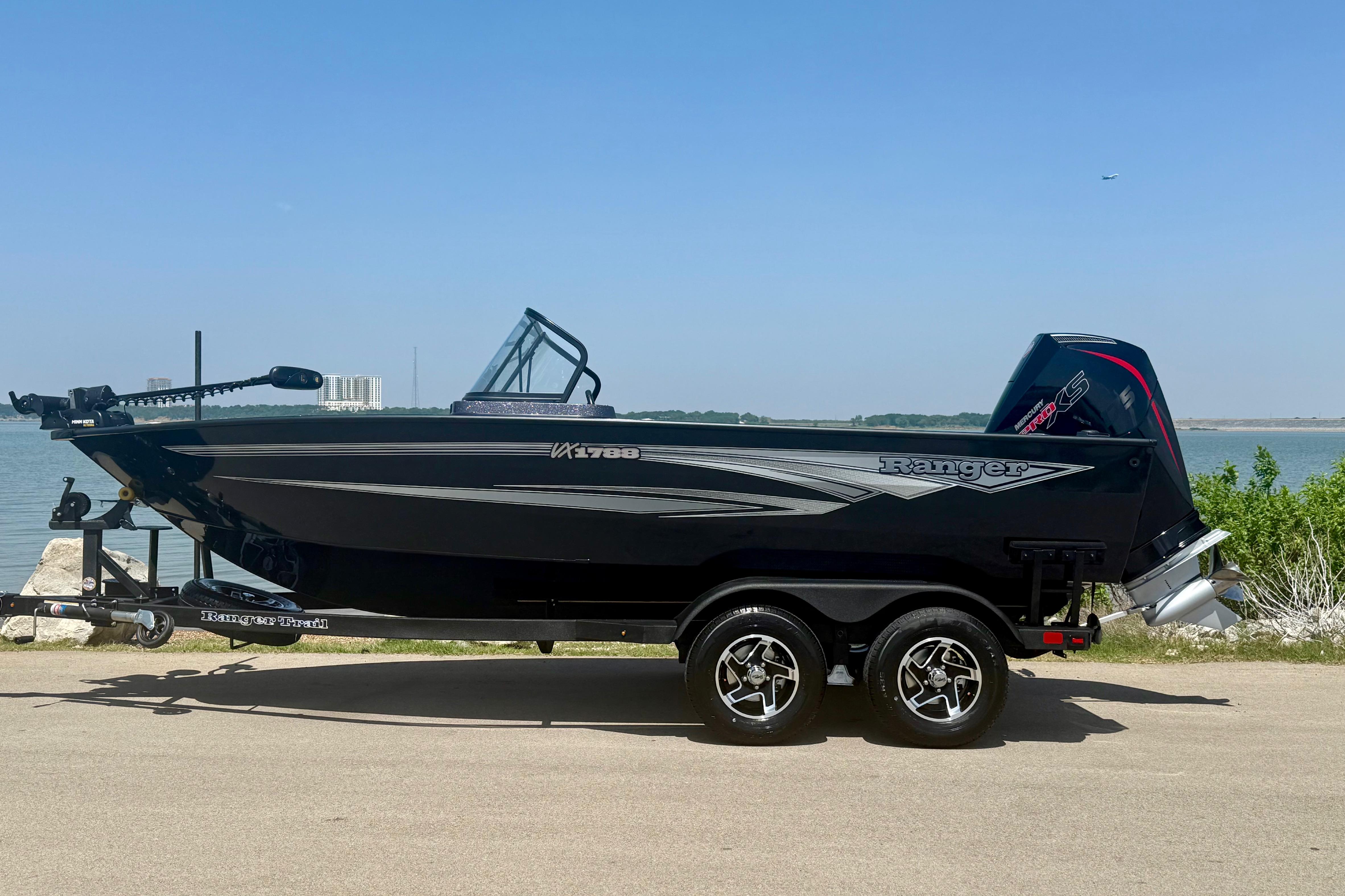 2026 Ranger VX1788 WT boat on trailer by a lake, clear sky background.
