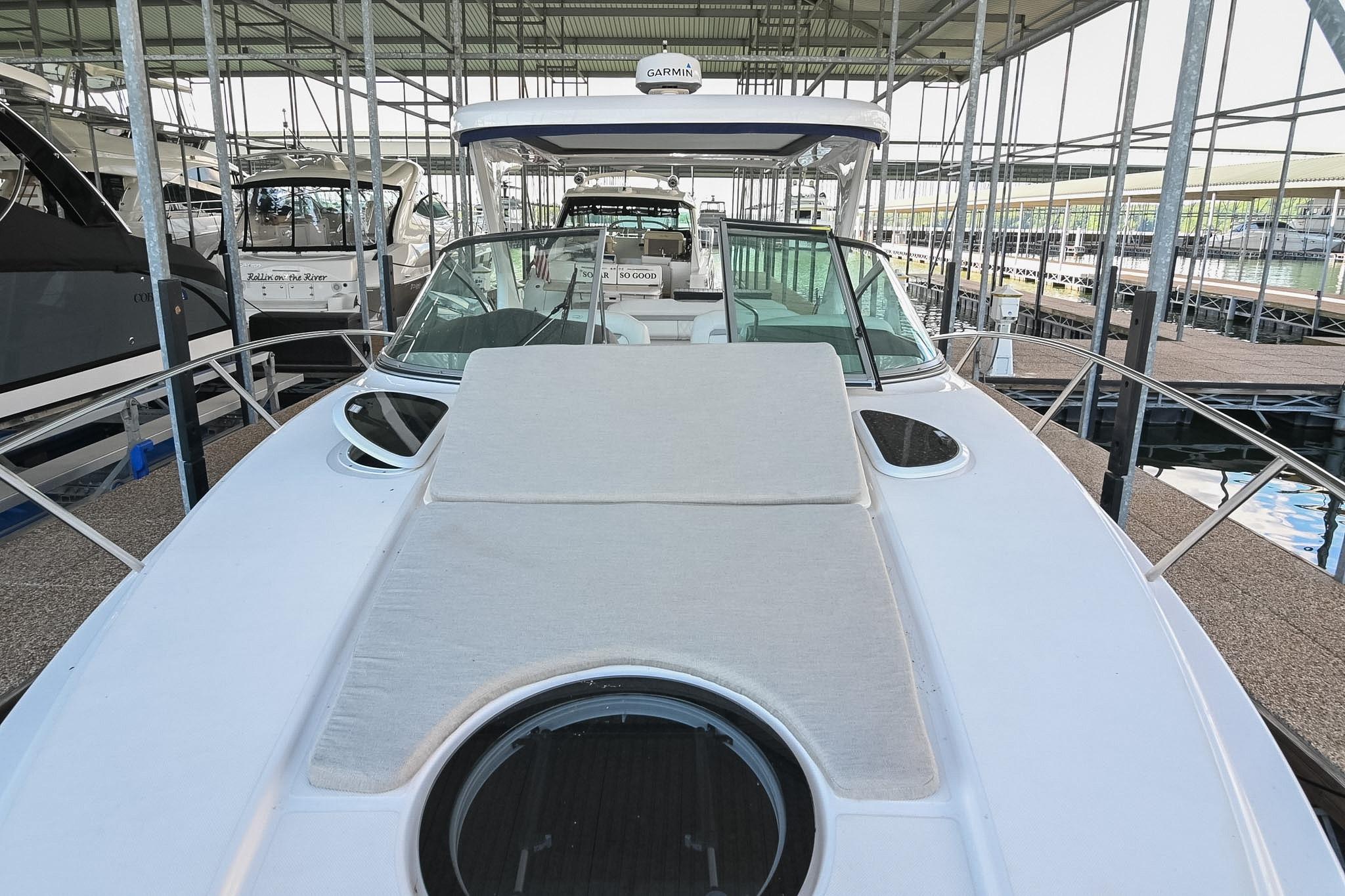 2021 Regal 33 Express boat docked in a marina, showcasing sleek design and spacious deck.