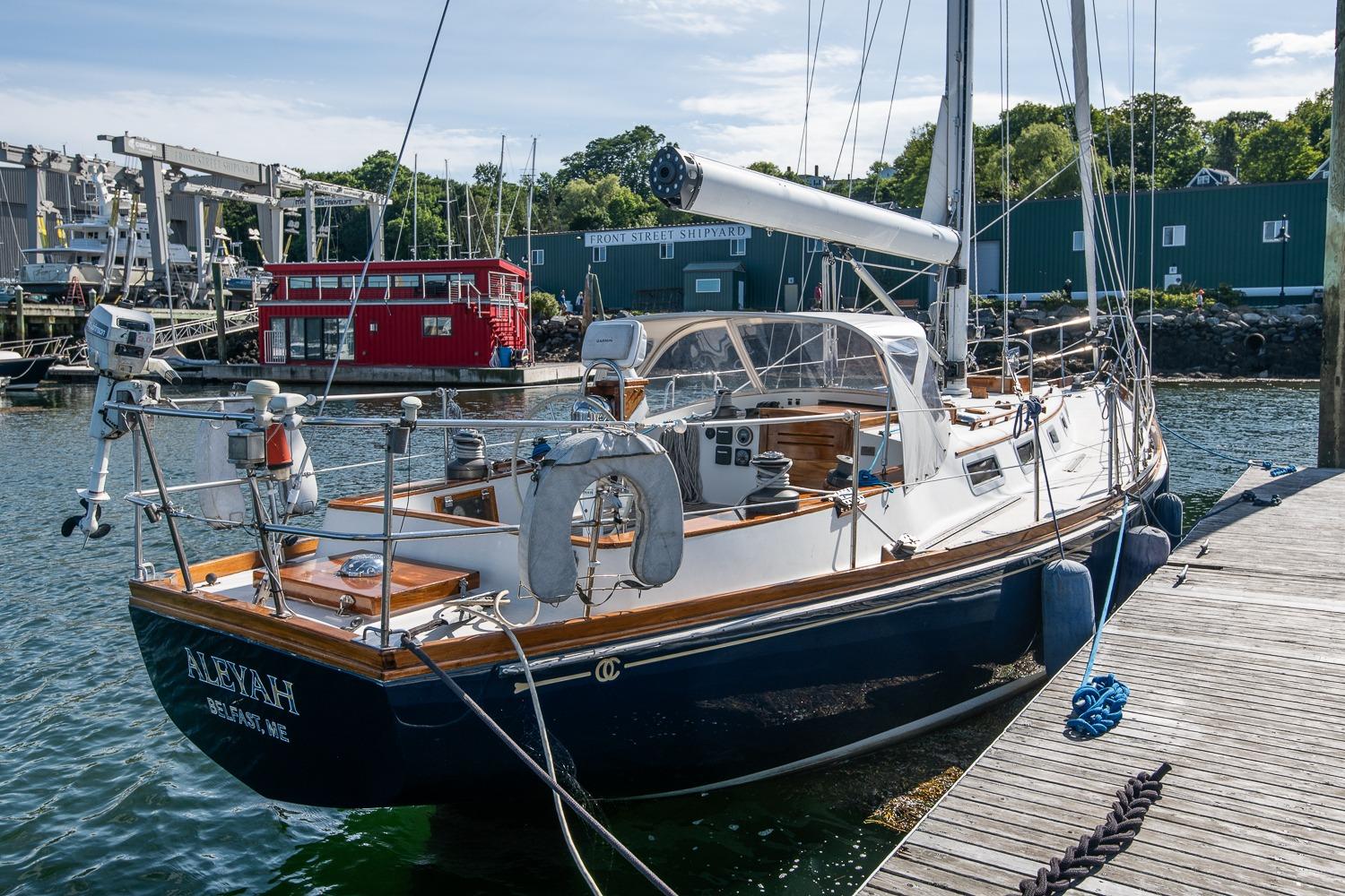 Sailboat docked at marina, Hank Hinckley OC42, 1984 model, sunny day.