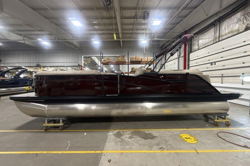 2026 Bennington 24 LXS Quadbench pontoon boat in a spacious indoor facility.