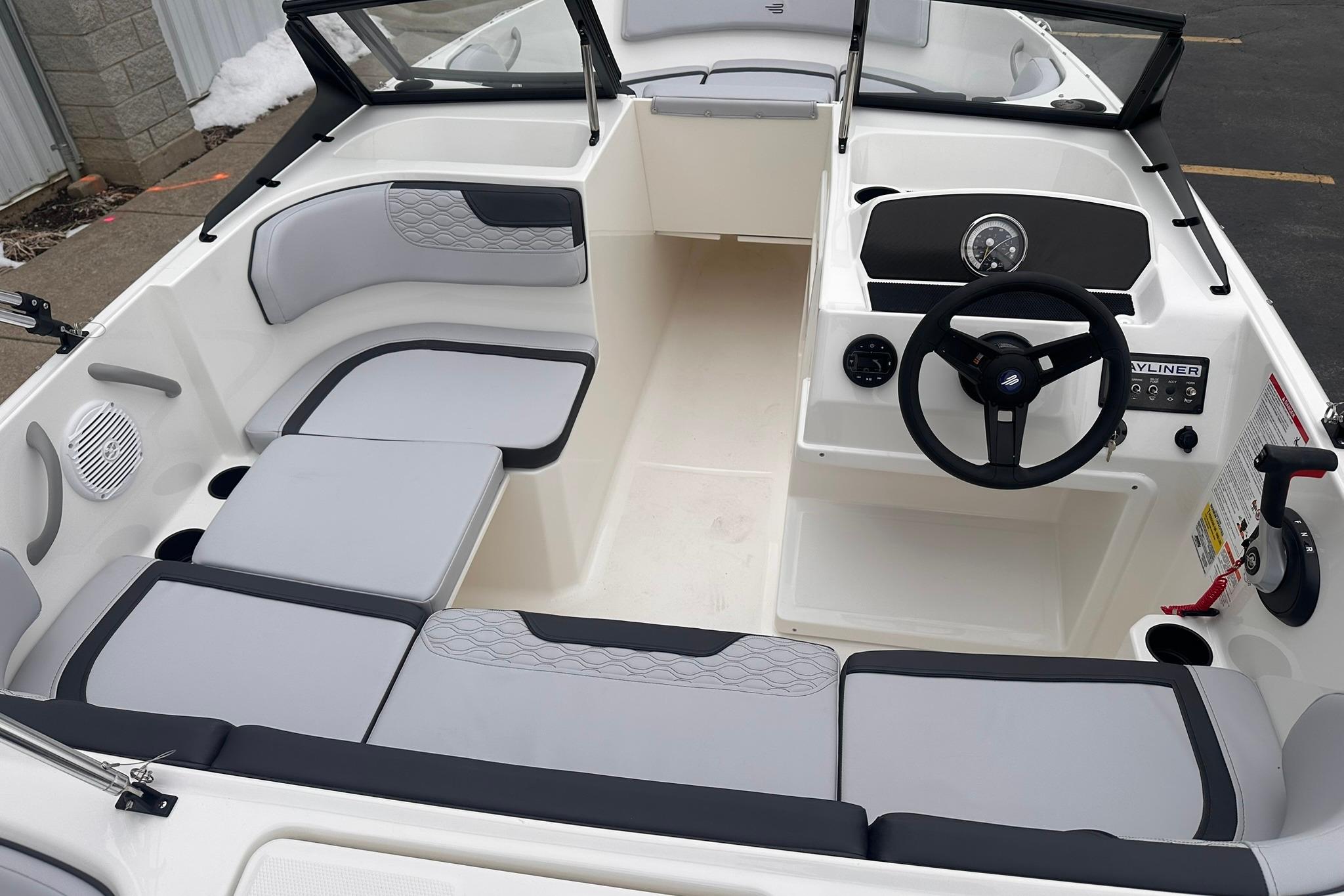 2026 Bayliner M17 boat interior with modern seating and steering wheel.