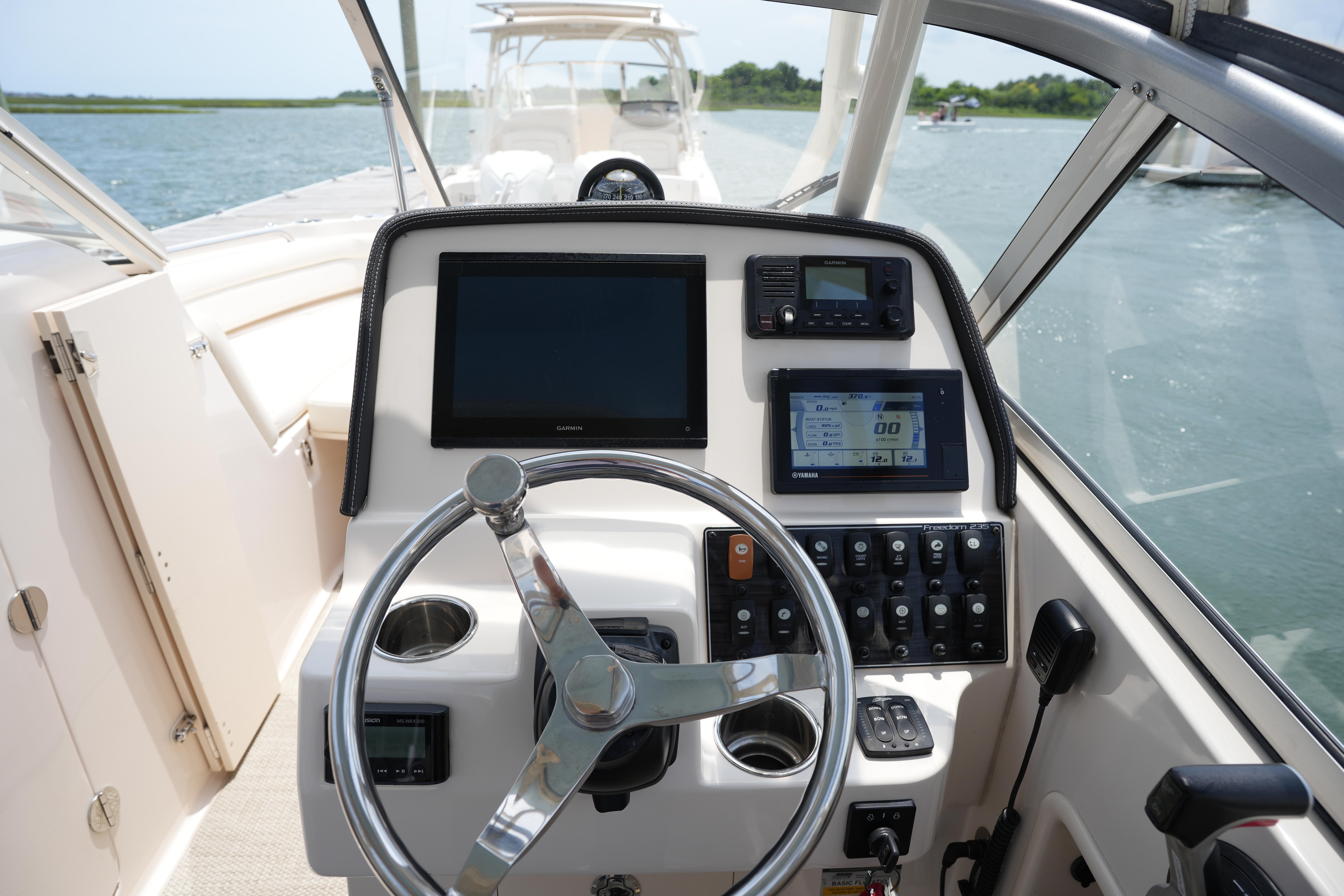 2021 Grady-White Freedom 235 boat dashboard with steering wheel and navigation controls.