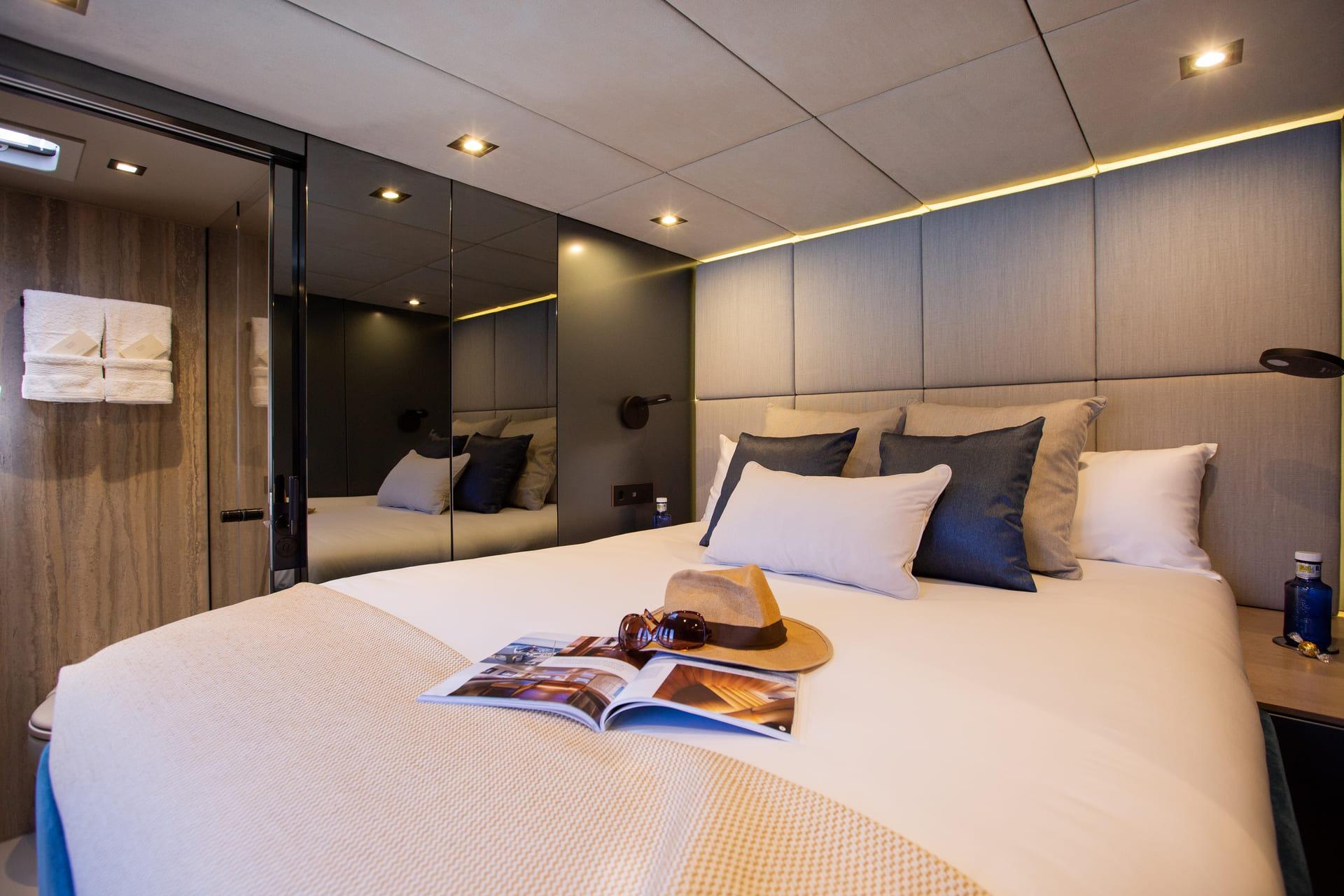 Luxurious Sunreef 60 yacht bedroom interior, featuring elegant bedding and modern decor, 2021 model.